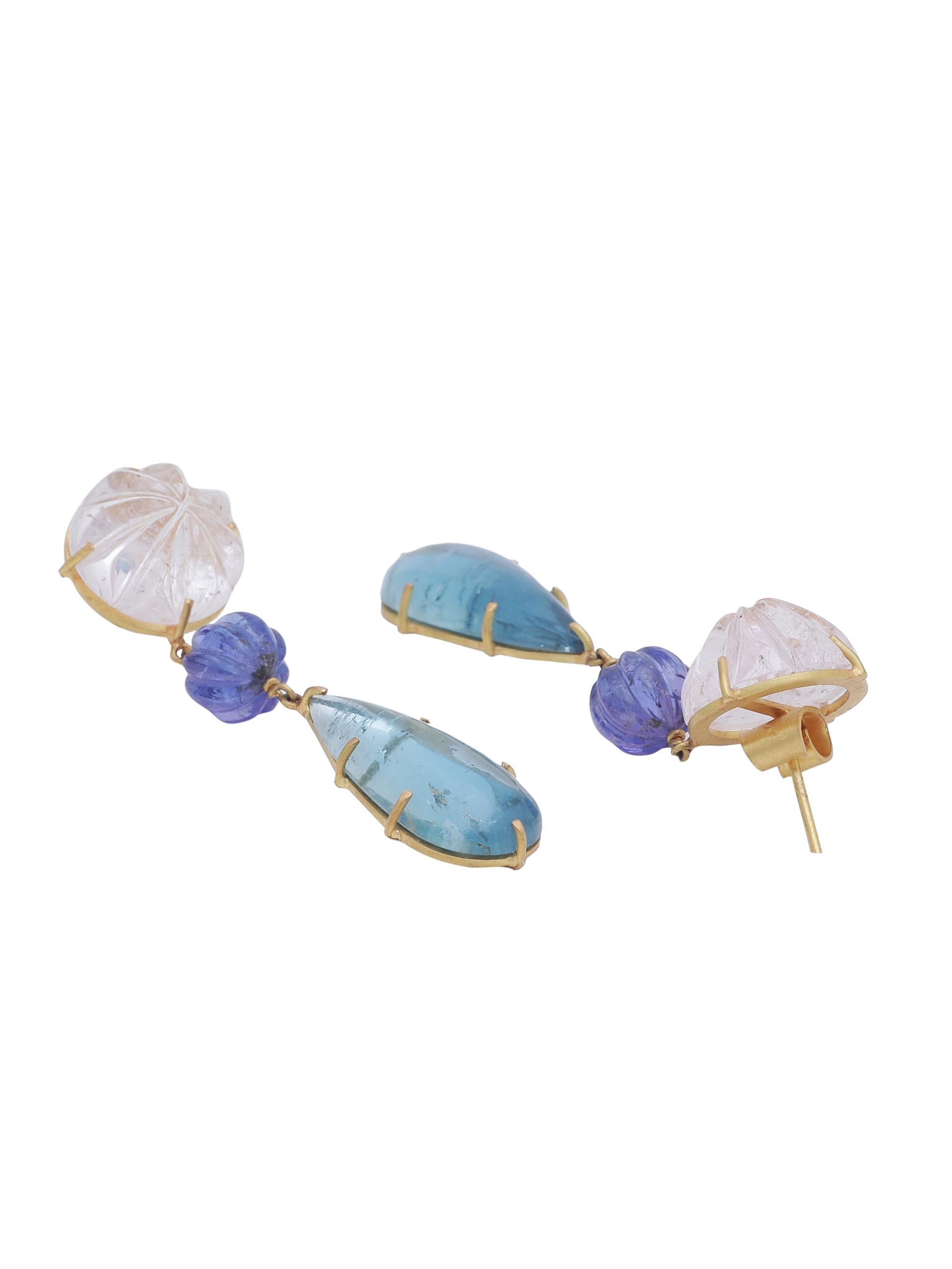 A pair of earrings hand crafted in 22K matte finish gold. The earring has a beautiful hand carved Kunzite on top, in the centre is a pair of Tanzanite carved bead and a nice pear shape aquamarine cabochon pair dangling at the end. 
All pastel colors