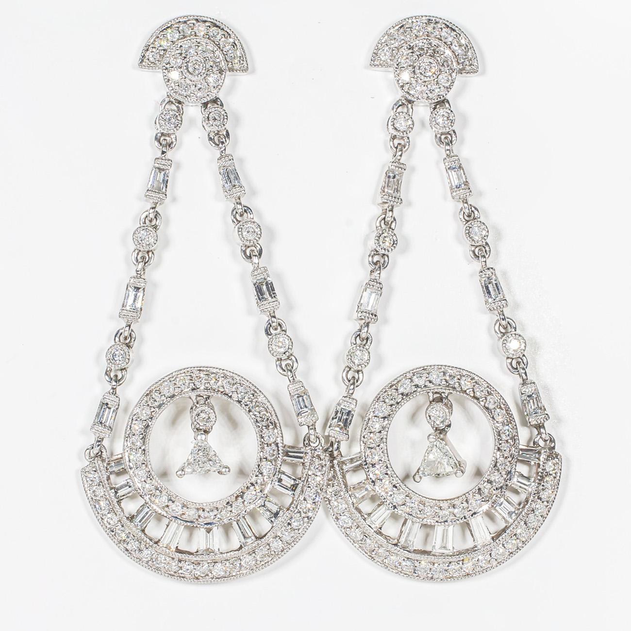 Dangling earrings in white gold with channel set baguettes, pave and bezel set rounds, and prong set trilliant cut diamonds.  D2.25ct.t.w.