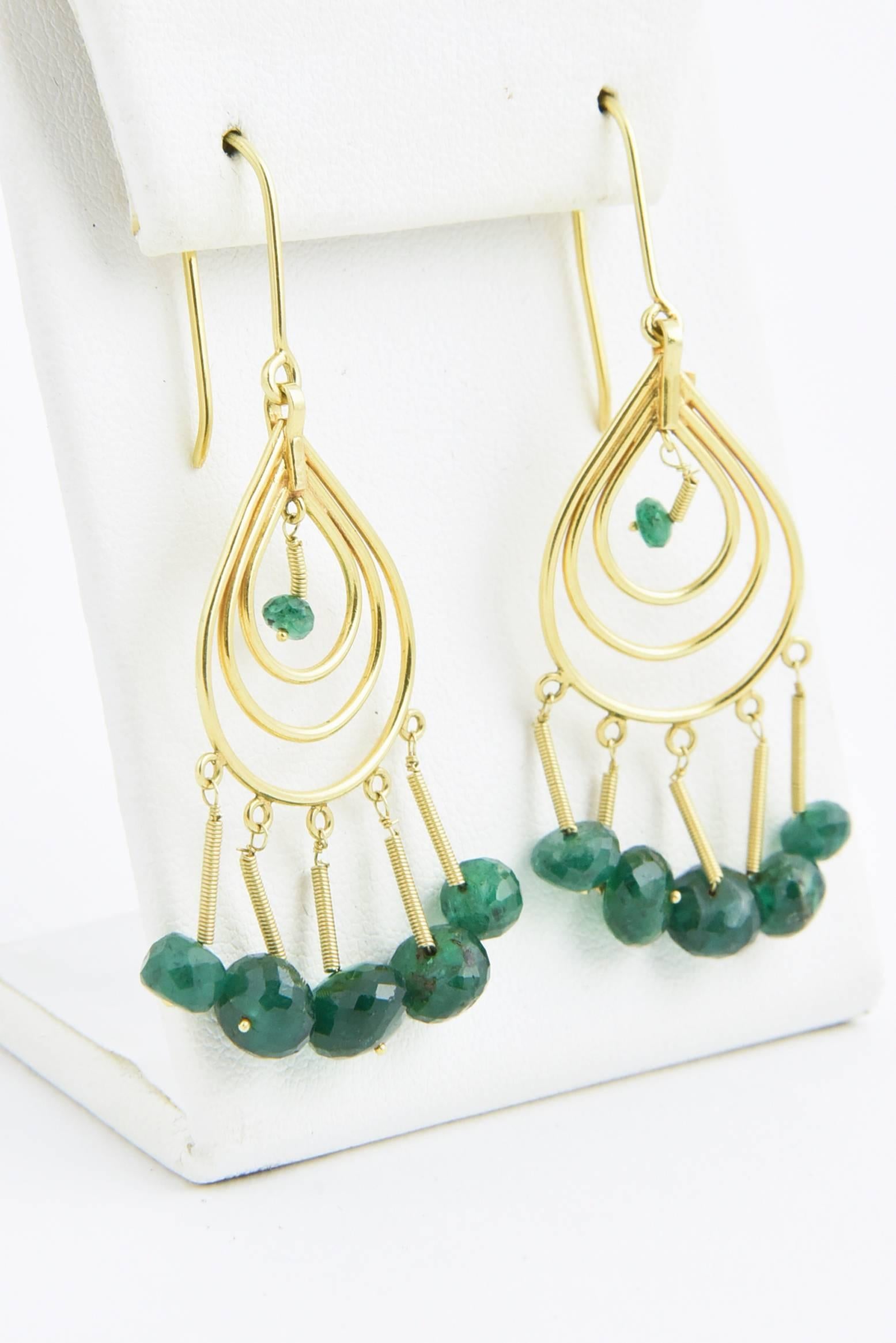 Dangling emeralds that dance on your ears on 18k gold tear drops and gold springs. French wire. Marked on back.
