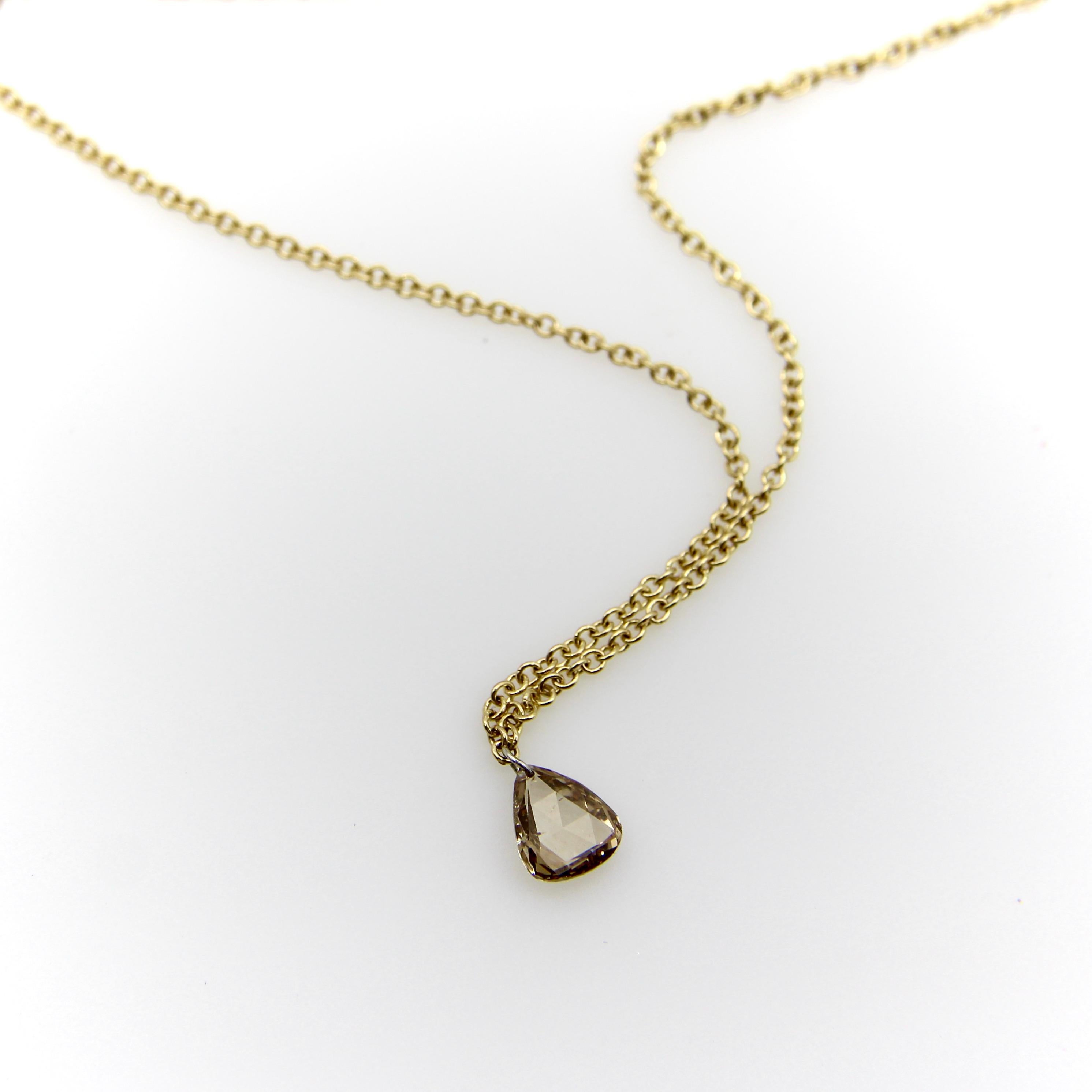 Part of our Signature Collection, we made this 14k gold and cognac diamond necklace by sending the diamond to have a tiny hole drilled in its corner so that it could dangle without a mount. To drill a diamond is a labor intensive process that