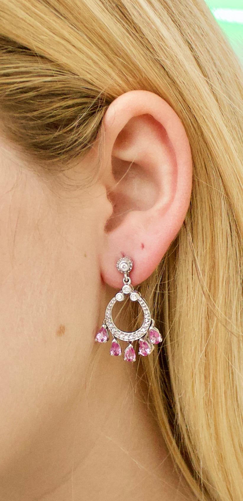 Dangling Pink Sapphire and Diamond Earrings in White Gold
10 Pear Shape Cut Pink Sapphires Weighing 2.00 Carats Approximately [bright with no imperfections visible to the naked eye]
38 Round Brilliant Cut Diamonds Weighing .40 Carats Approximately 
