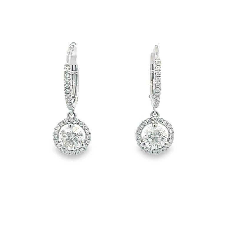 Elevate your style with these exquisite diamond earrings that display elegance and sophistication. Each earring features a high-quality white one-round diamond in H color and SI clarity in the center in 1.31 carats weight, a stunning display of