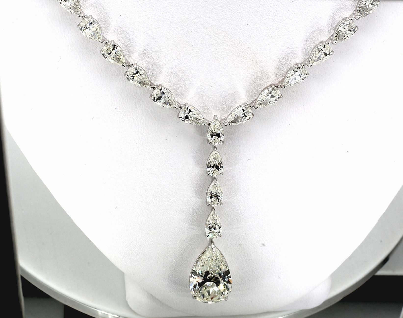 Dangling tennis necklace in platinum with basket prong set pear shape diamonds (55 stones) and drop dangling GIA certified J/SI2 pear shape diamond center stone.  D36.13ct.t.w. - Center 8.02ct.