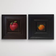 Diptych of Pocket Yellowy Orange Clementine and Very Shiny Very Red Apple