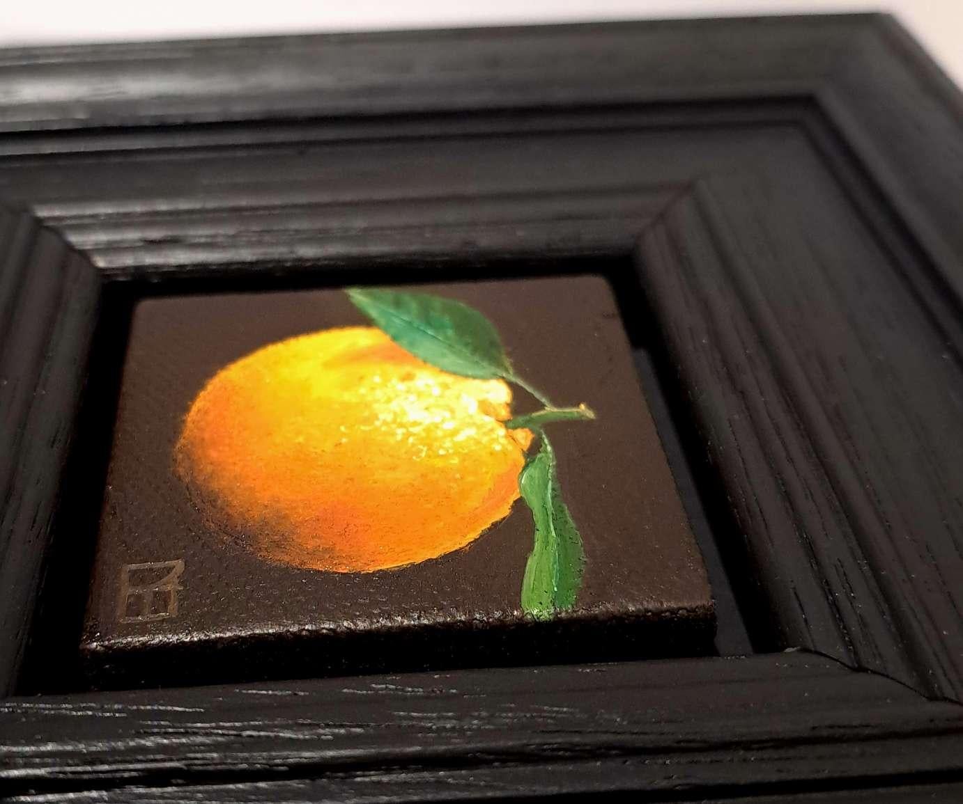 Pocket Yellowy Orange Clementine is an original oil painting by Dani Humberstone as part of her Pocket Painting series featuring small scale realistic oil paintings, with a nod to baroque still life painting. The paintings are set in a black wood