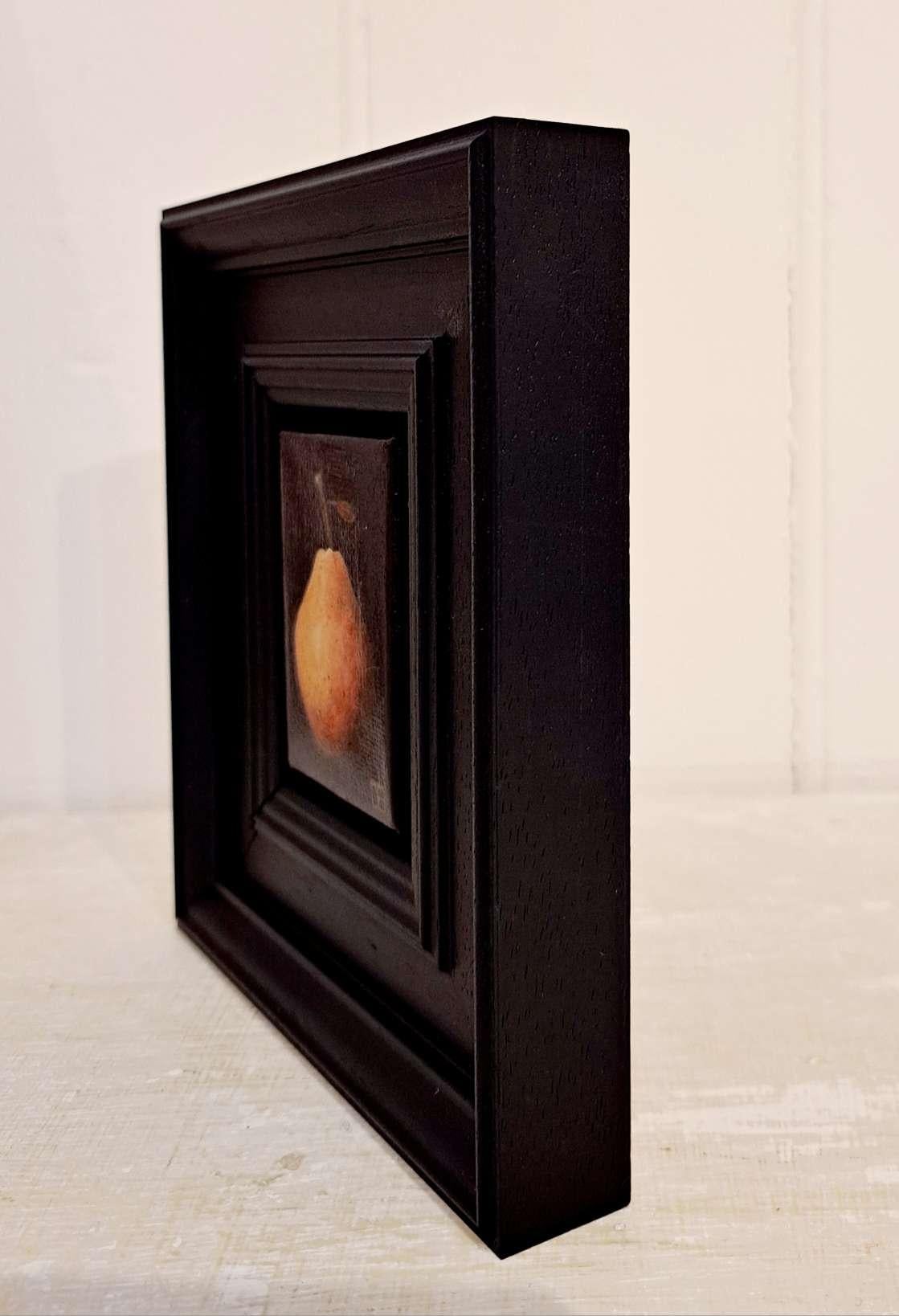 Pocket Blush Pear is an original oil painting by Dani Humberstone as part of her Pocket Painting series featuring small scale realistic oil paintings, with a nod to baroque still life painting. The paitings are set in a black wood layered