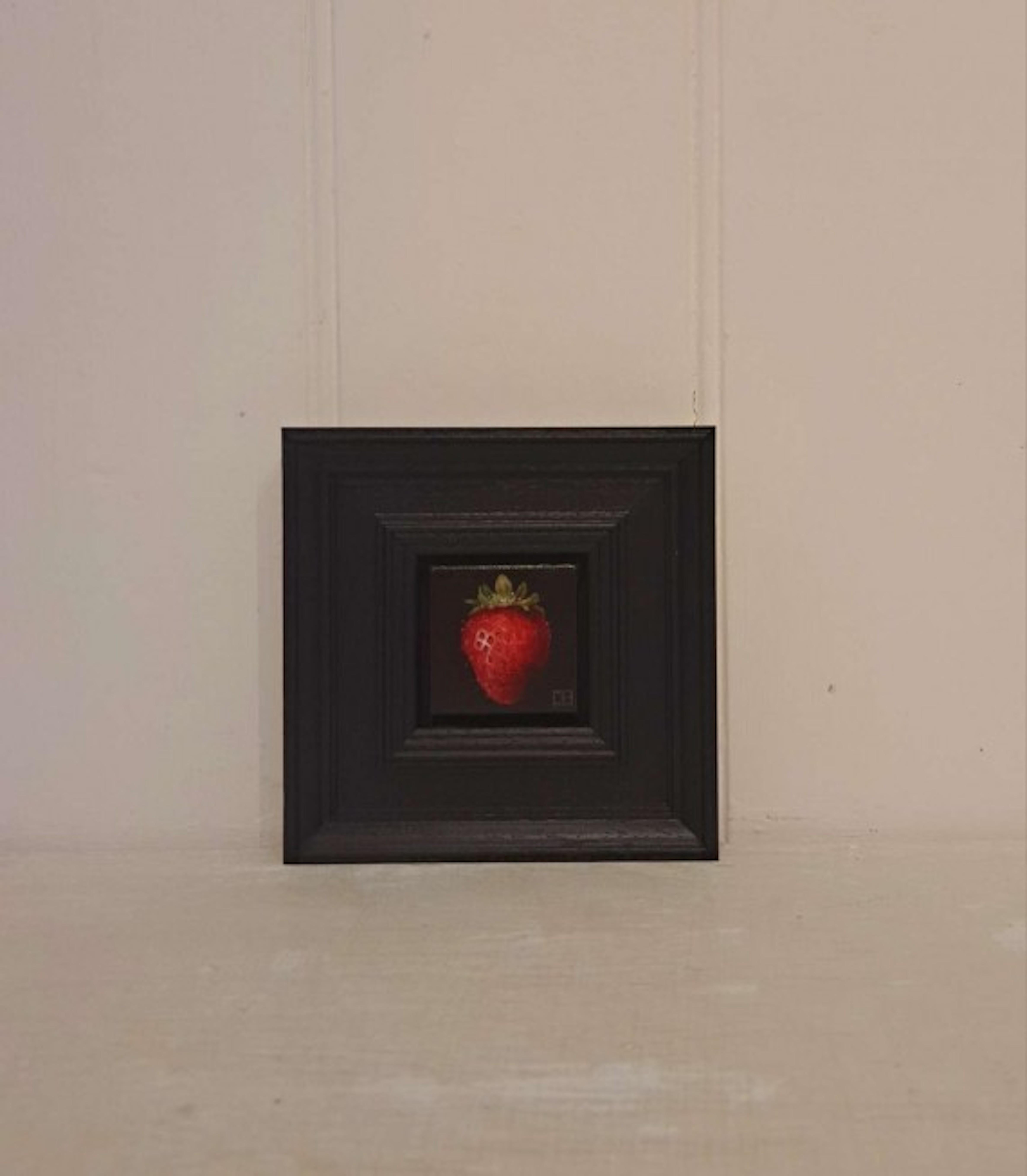 Pocket Crimson Strawberry is an original oil painting by Dani Humberstone as part of her Pocket Painting series featuring small scale realistic oil paintings, with a nod to baroque still life painting. The paintings are set in a black wood layered