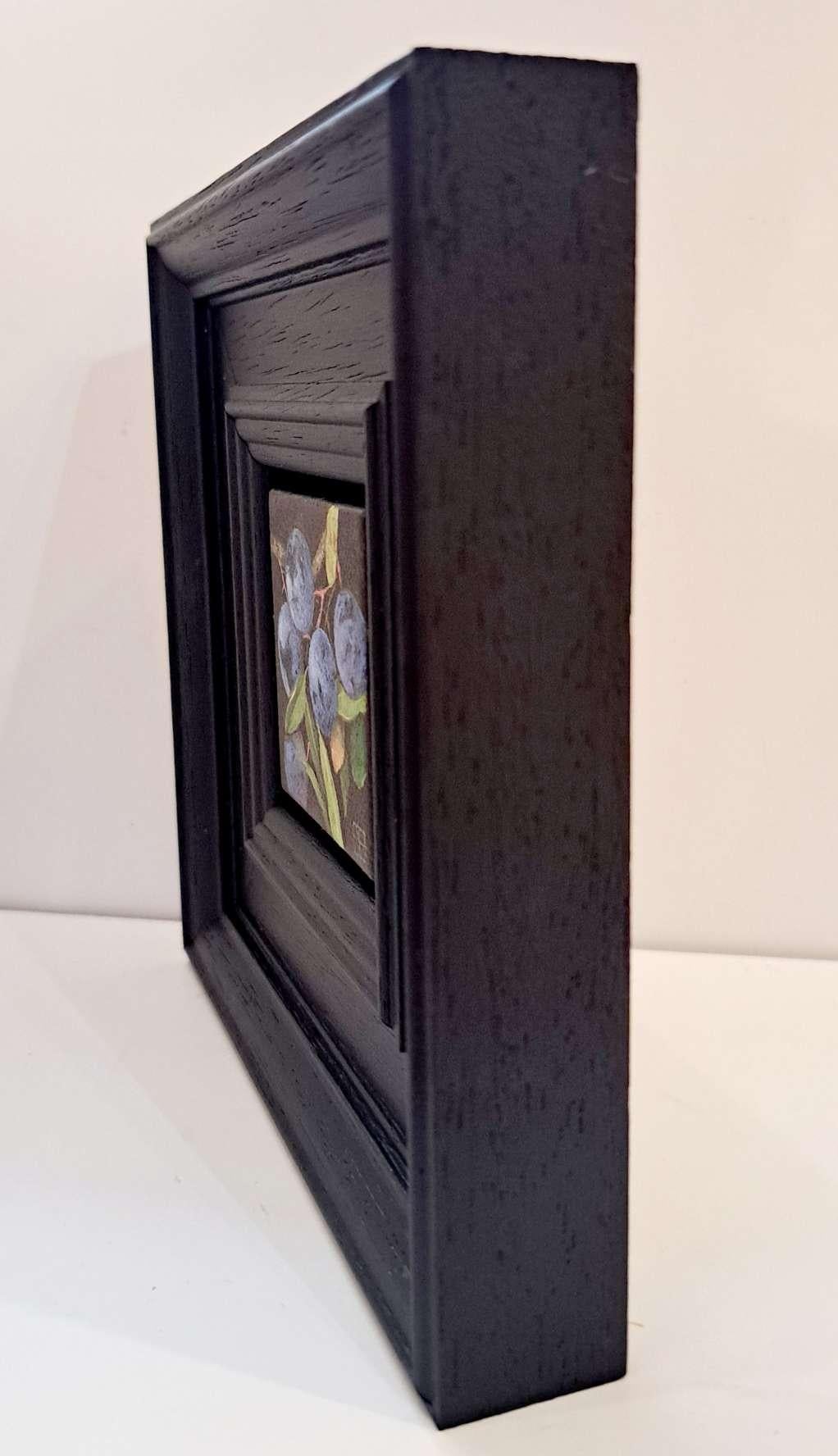 Pocket Pale Blue Sloes 2 is an original oil painting by Dani Humberstone as part of her Pocket Painting series featuring small scale realistic oil paintings, with a nod to baroque still life painting. The paintings are set in a black wood layered