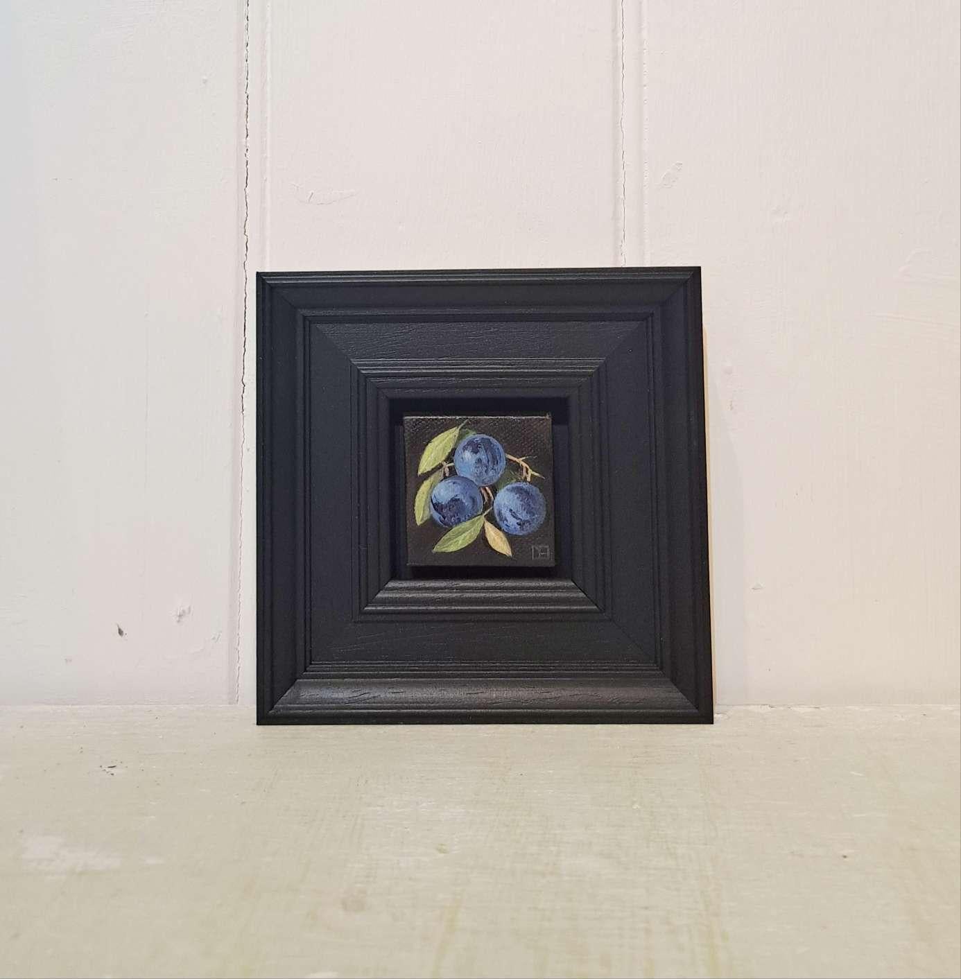 Pocket Pale Blue Sloes is an original oil painting by Dani Humberstone as part of her Pocket Painting series featuring small scale realistic oil paintings, with a nod to baroque still life painting. The paintings are set in a black wood layered