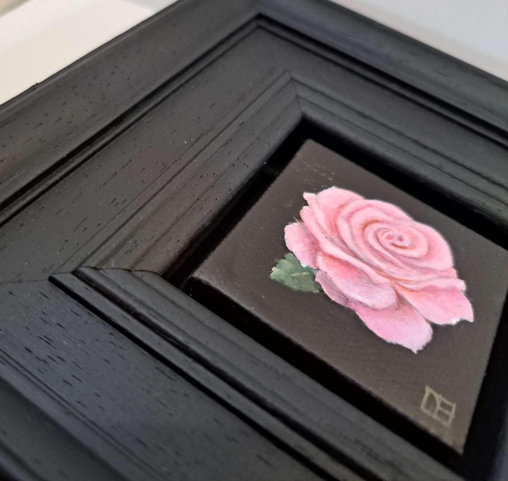 Pocket Pink Rose with Leaf 2 is an original oil painting by Dani Humberstone as part of her Pocket Painting series featuring small scale realistic oil paintings, with a nod to baroque still life painting. The paintings are set in a black wood