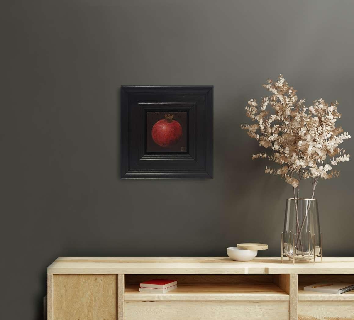 Pocket Pinky Red Pomegranate is an original oil painting by Dani Humberstone as part of her Pocket Painting series featuring small scale realistic oil paintings, with a nod to baroque still life painting. The paintings are set in a black wood