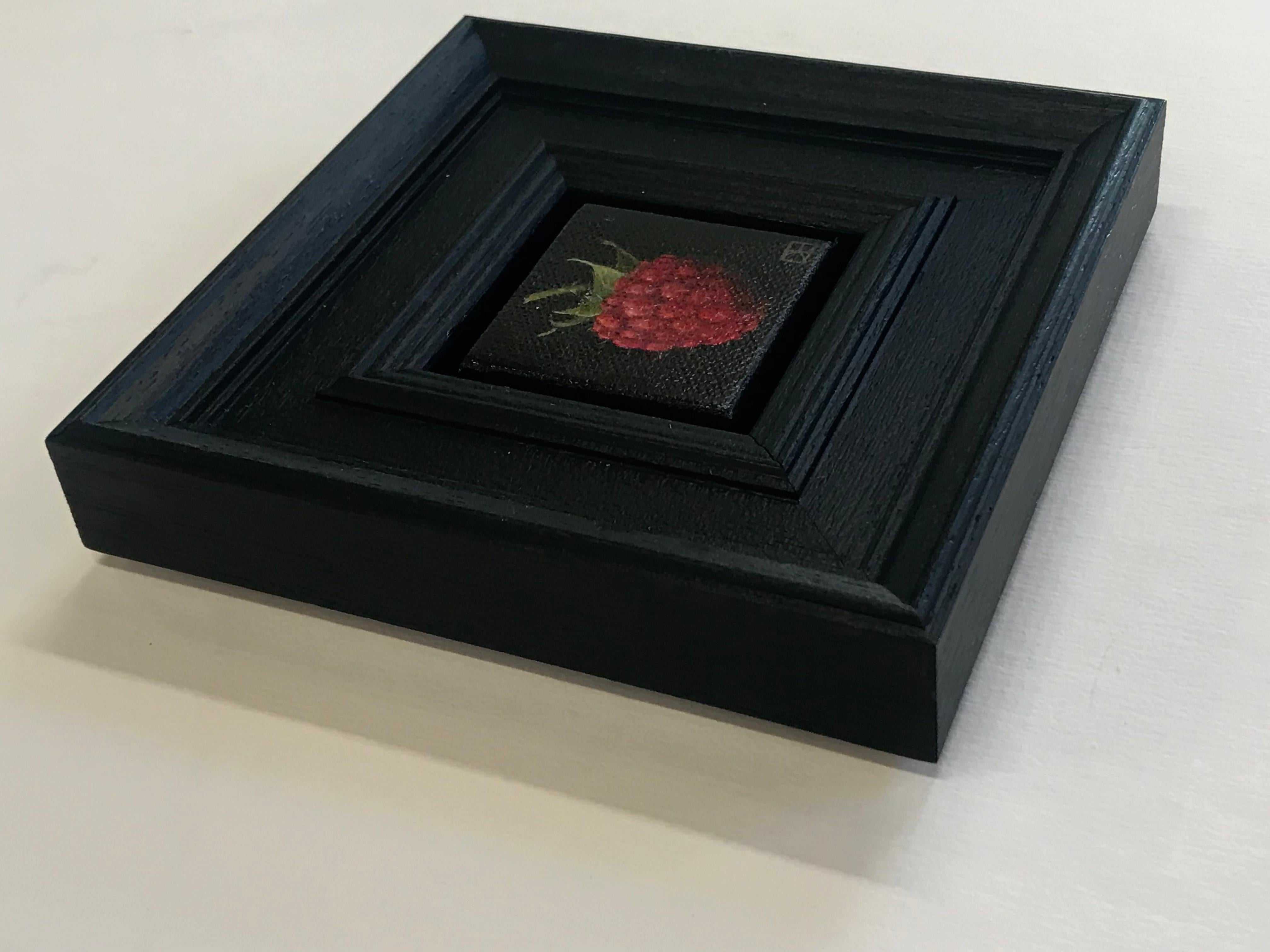 Pocket Raspberry is an original oil painting by Dani Humberstone as part of her Pocket Painting series featuring small scale realistic oil paintings, with a nod to baroque still life painting. The paintings are set in a black wood layered