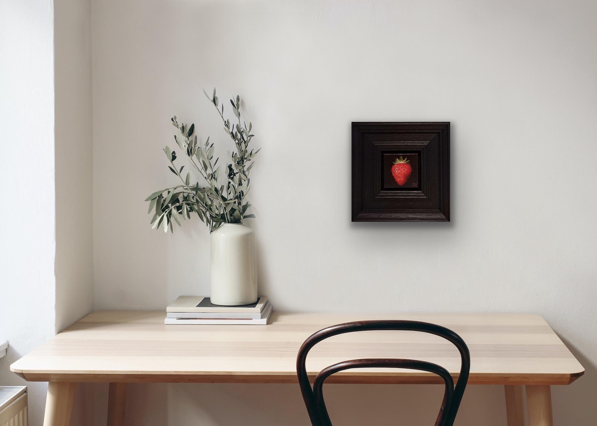 Pocket Red Strawberry is an original oil painting by Dani Humberstone as part of her Pocket Painting series featuring small scale realistic oil paintings, with a nod to baroque still life painting. The paitings are set in a black wood layered