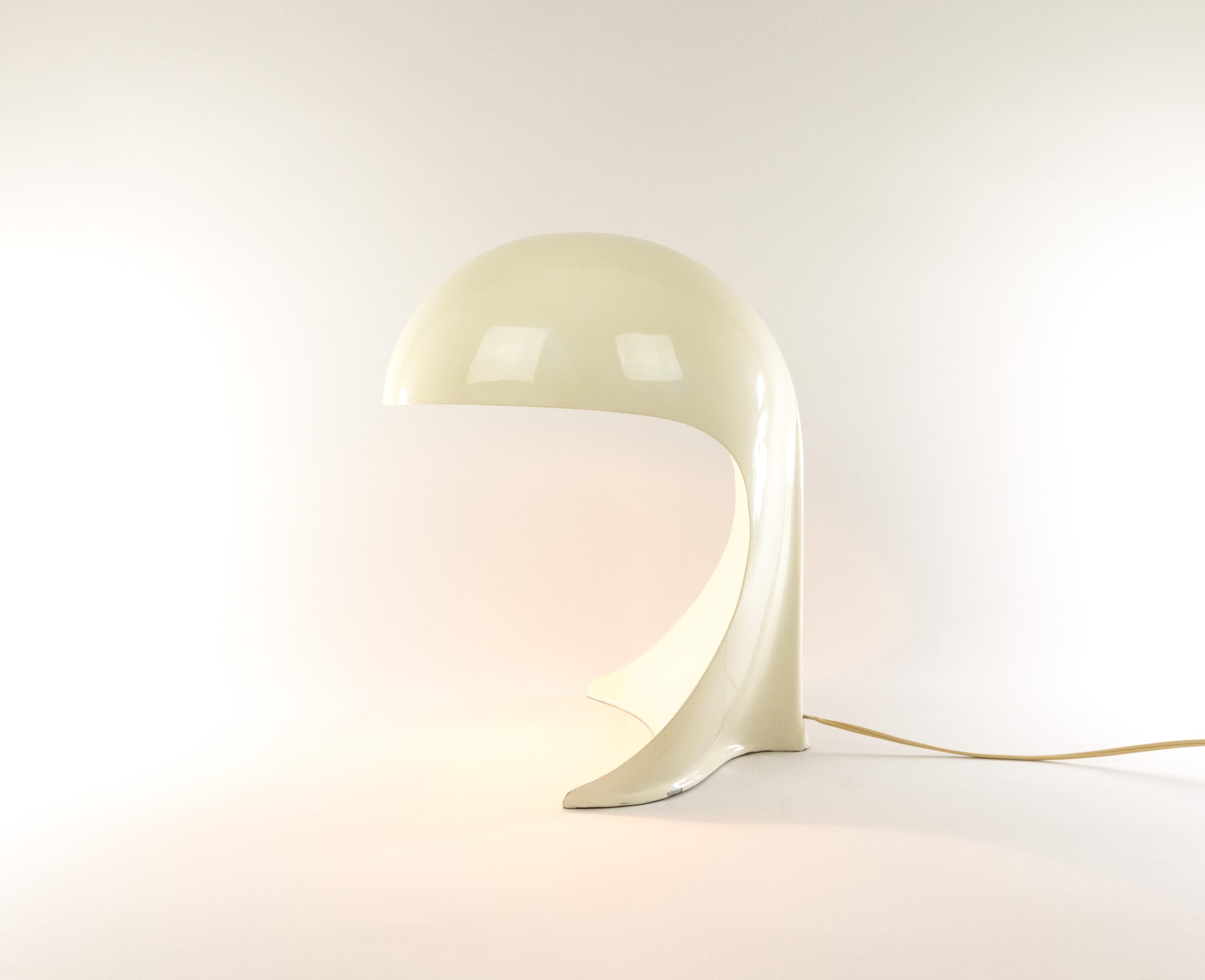 The Dania table lamp was designed by Dario Tognon in collaboration with Studio Celli for Artemide. The sculptural and organic model was forged in one piece cast aluminium painted white. 

After the introduction in 1969 Artemide produced the lamp