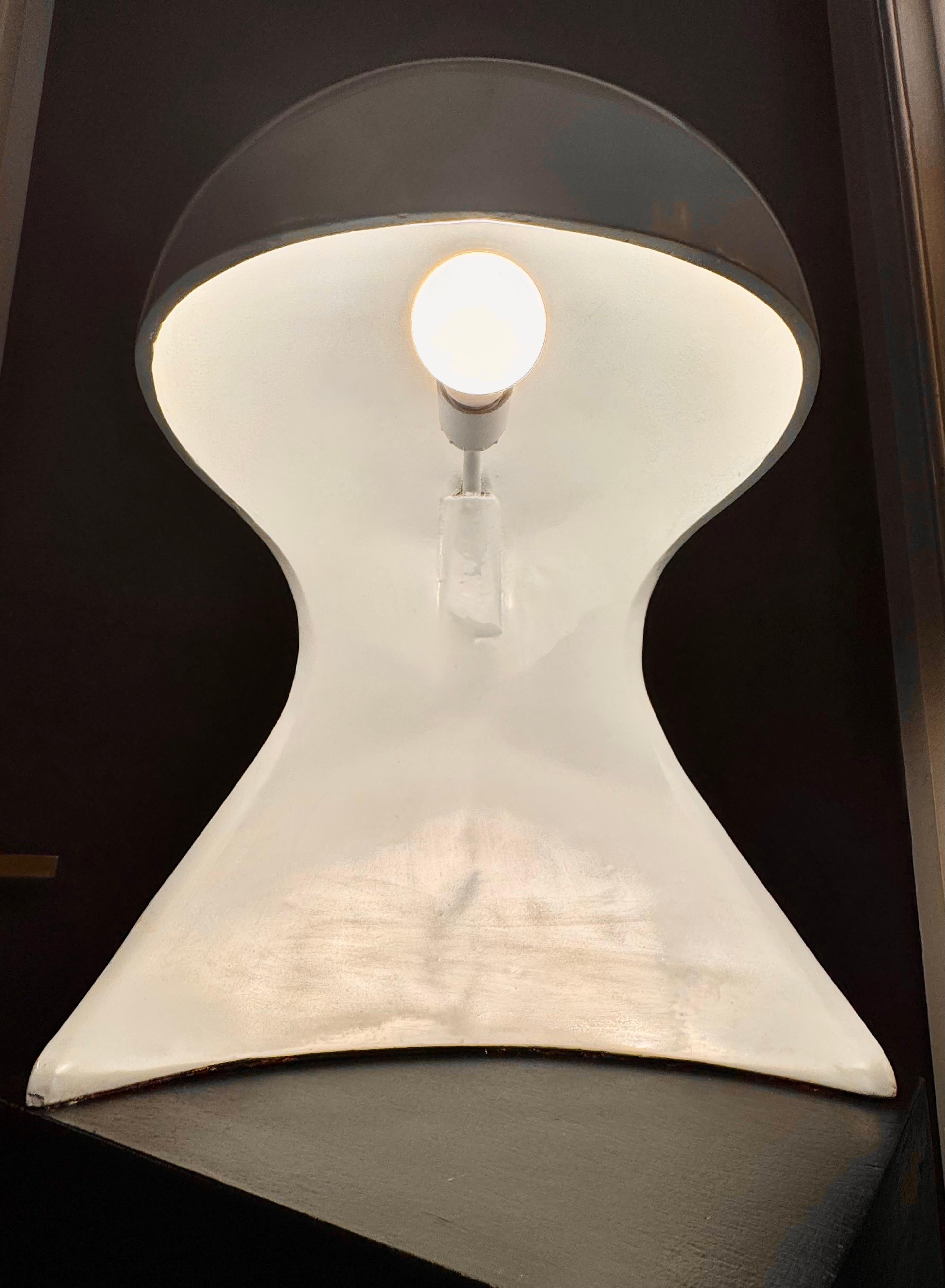 Introduce a piece of design history into your home with the Dania Table Lamp, a stunning creation by Dario Tognon and Studio Celli for the iconic Italian lighting brand Artemide. Released in the late 20th century, this lamp exemplifies the