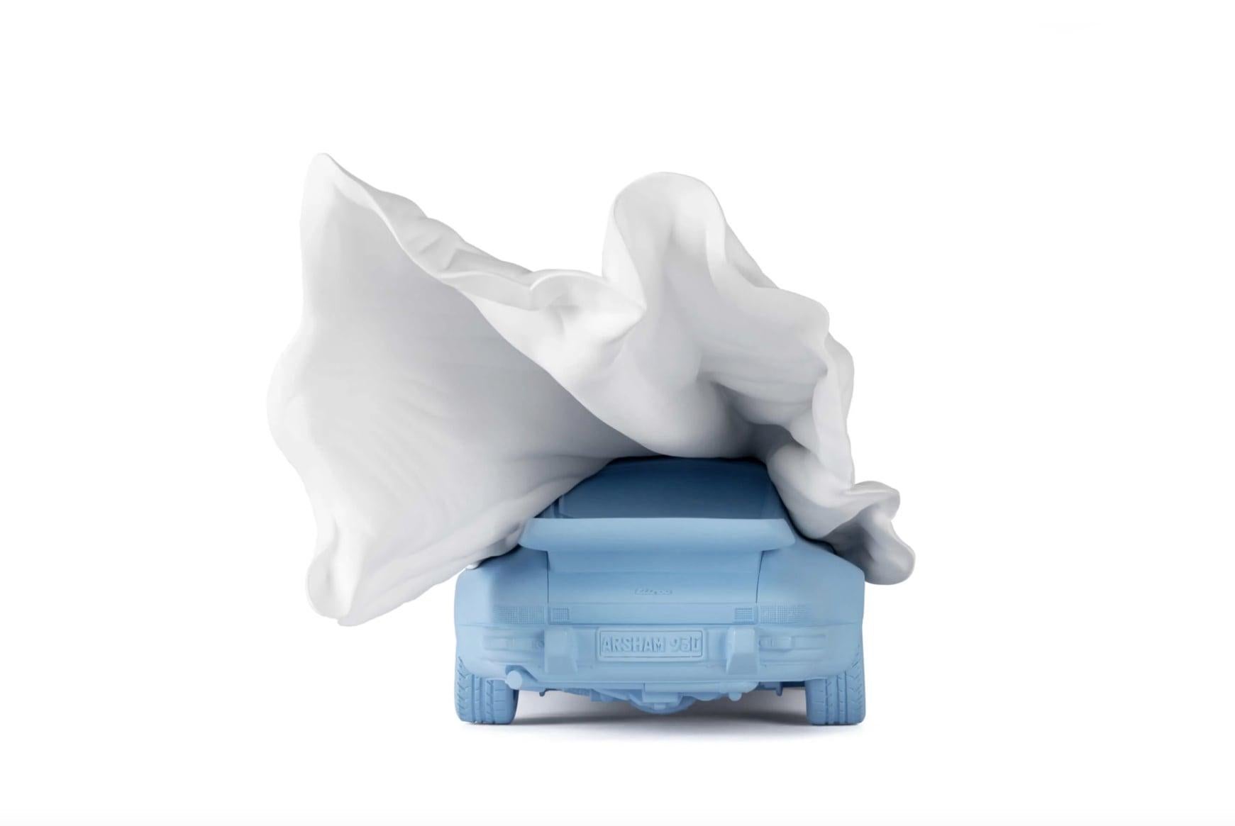 VEILED PORSCHE is an edition based on a sculpture depicting the iconic Porsche 930 Turbo mid-reveal as fabric is being blown off of it. Utilizing an Arsham drapery technique stemming from antiquity, the sculpture appears suspended in time,
