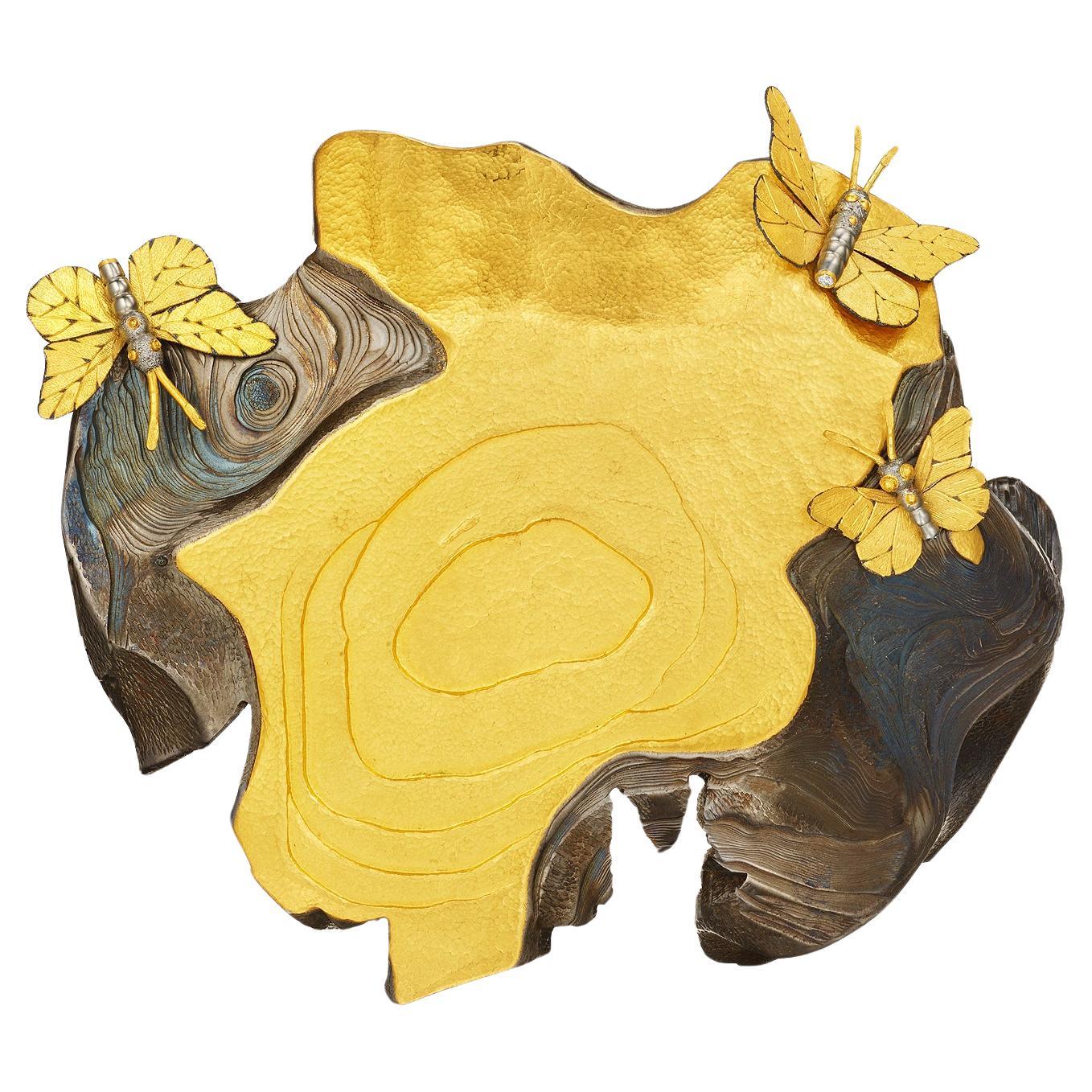 This extraordinarily powerful and enigmatically beautiful vintage Daniel Brush gold and steel sculpture is a jewel not to be worn but cherished.  Entitled 'Water Stone' this enchanting hand carved steel and 22 karat yellow gold waterscape features