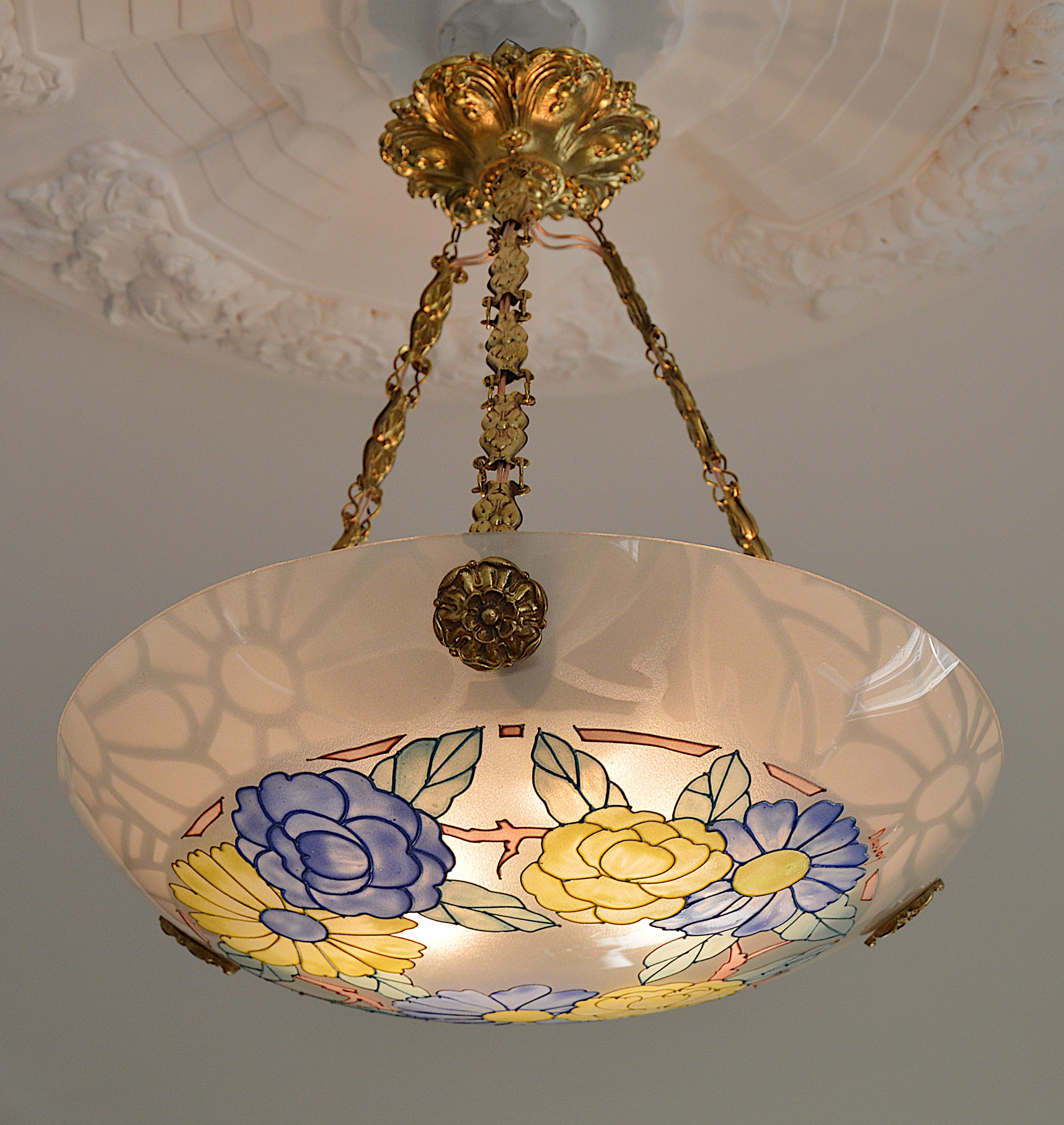 French Art Deco chandelier by Daniel Drancourt, 7, rue bleue, (Paris), France, 1920s. Etched (edge) and enameled (pattern) glass shade hung at its bronze and stamped brass fixture. Height : 15