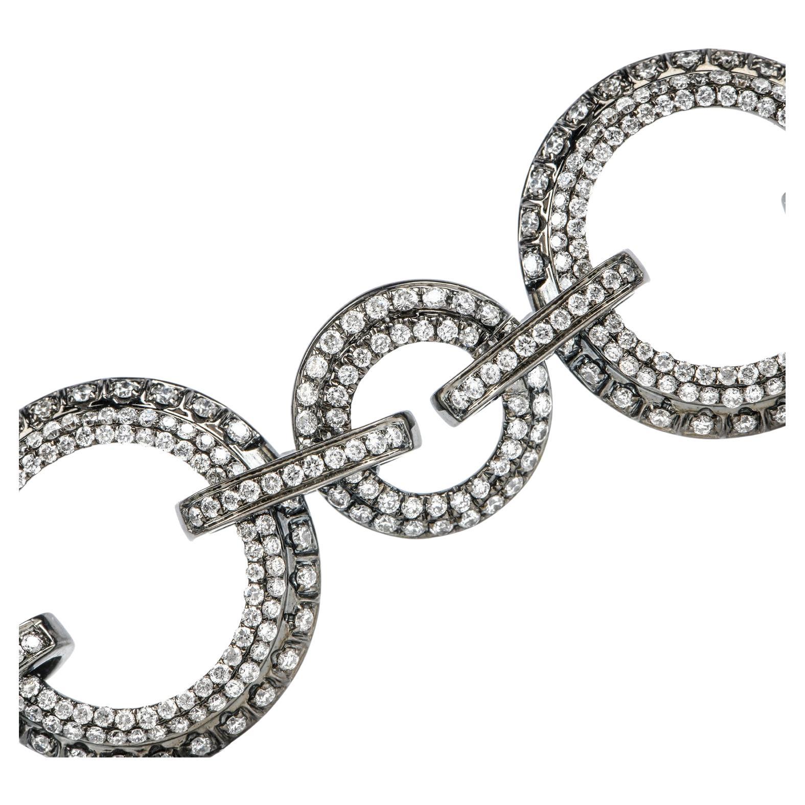 Feel flirty and daring with this fashionable Estate Diamond 18K Gold Circle Chain Link Bracelet.  This bracelet is crafted in the trending 18-karat white gold with chic black rhodium plating.  There are glimmering genuine white diamonds, round cut,