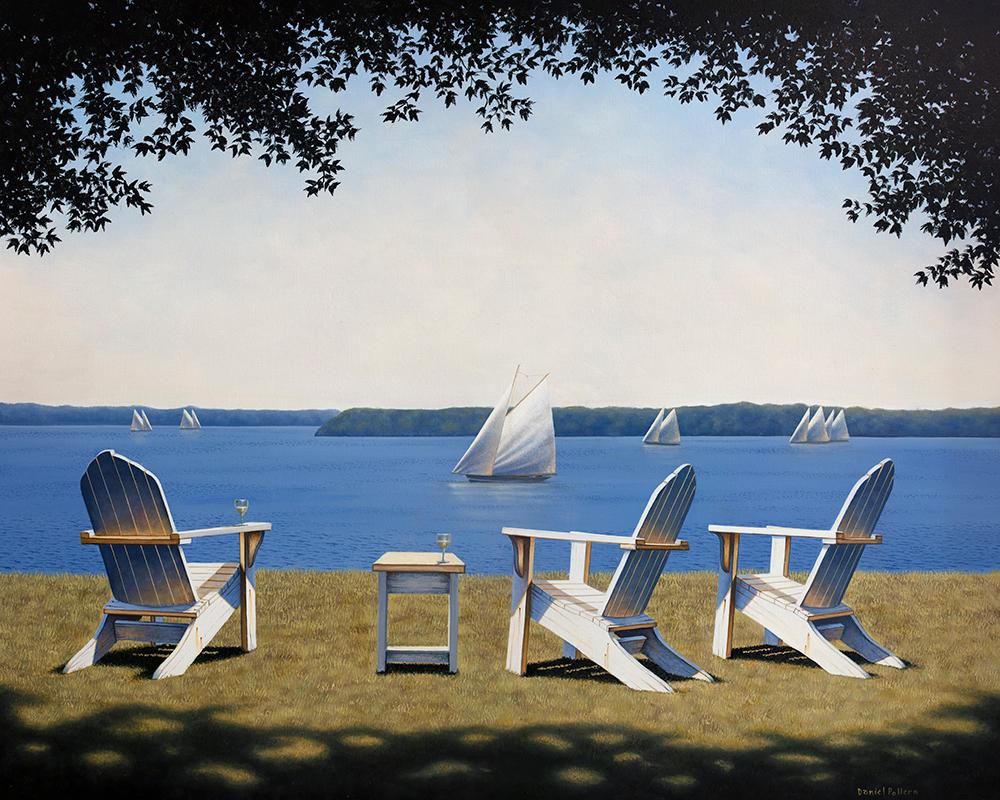 This traditional coastal Limited Edition print by Daniel Pollera pictures three white Adirondack chairs, positioned in the grass overlooking a body of water. Several sailboats can be seen close up and further out along the horizon line. A pale blue