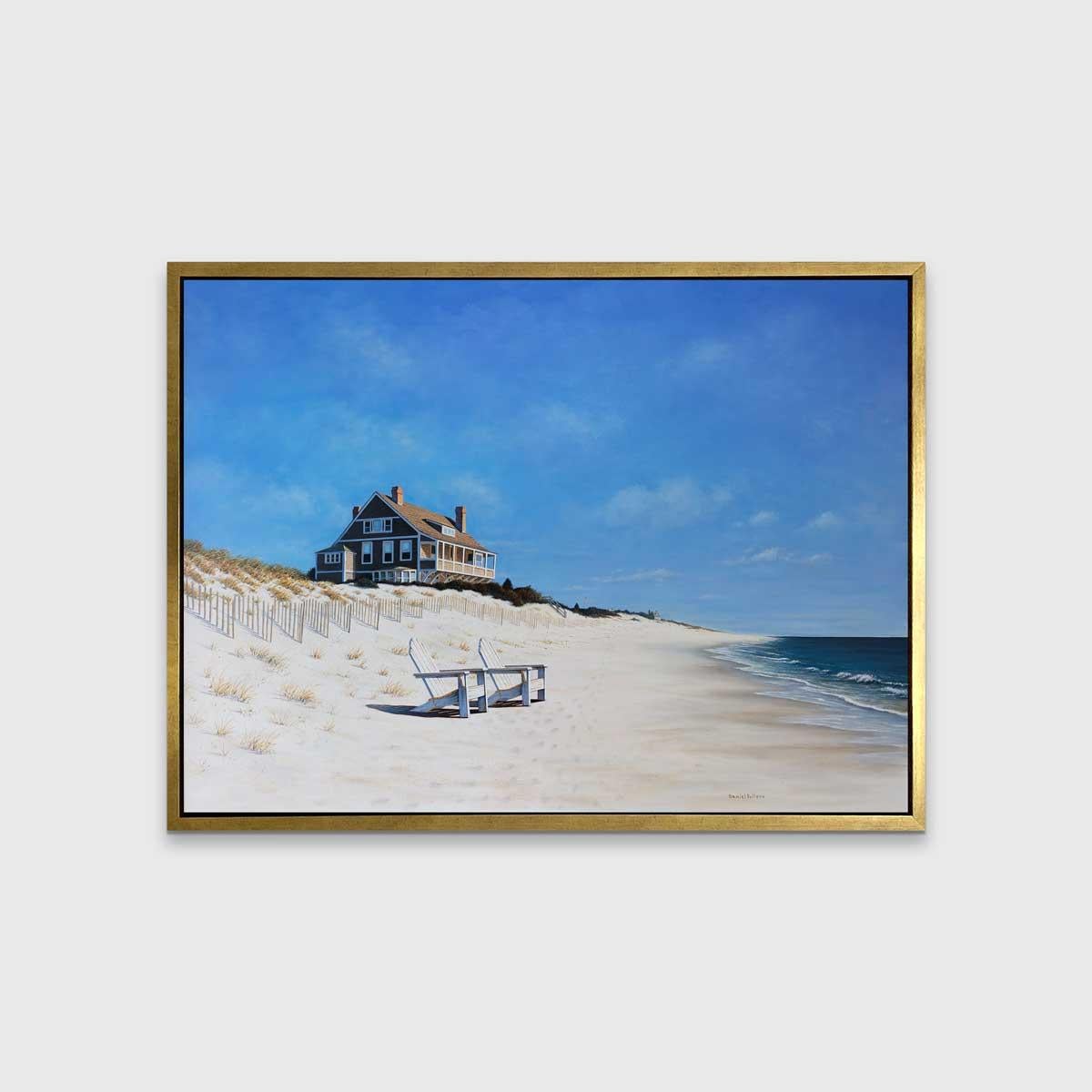 This contemporary coastal landscape is a Limited Edition print by Daniel Pollera. It depicts a sandy beach with waves rolling in from the right-hand side of the composition. Two Adirondack chairs are seated on the beach, in front of wooden fencing,