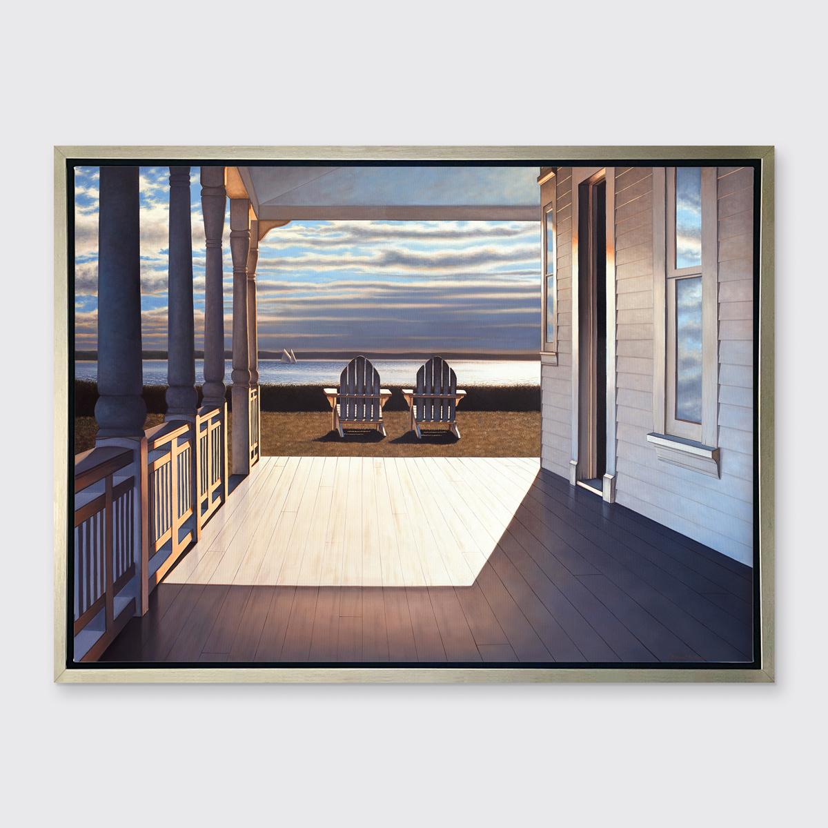 This contemporary realist Limited Edition print by Daniel Pollera is rendered from the perspective of a view from a beach house porch, looking out toward a body of water. Two Adirondack chairs are positioned on the grass between the edge of the