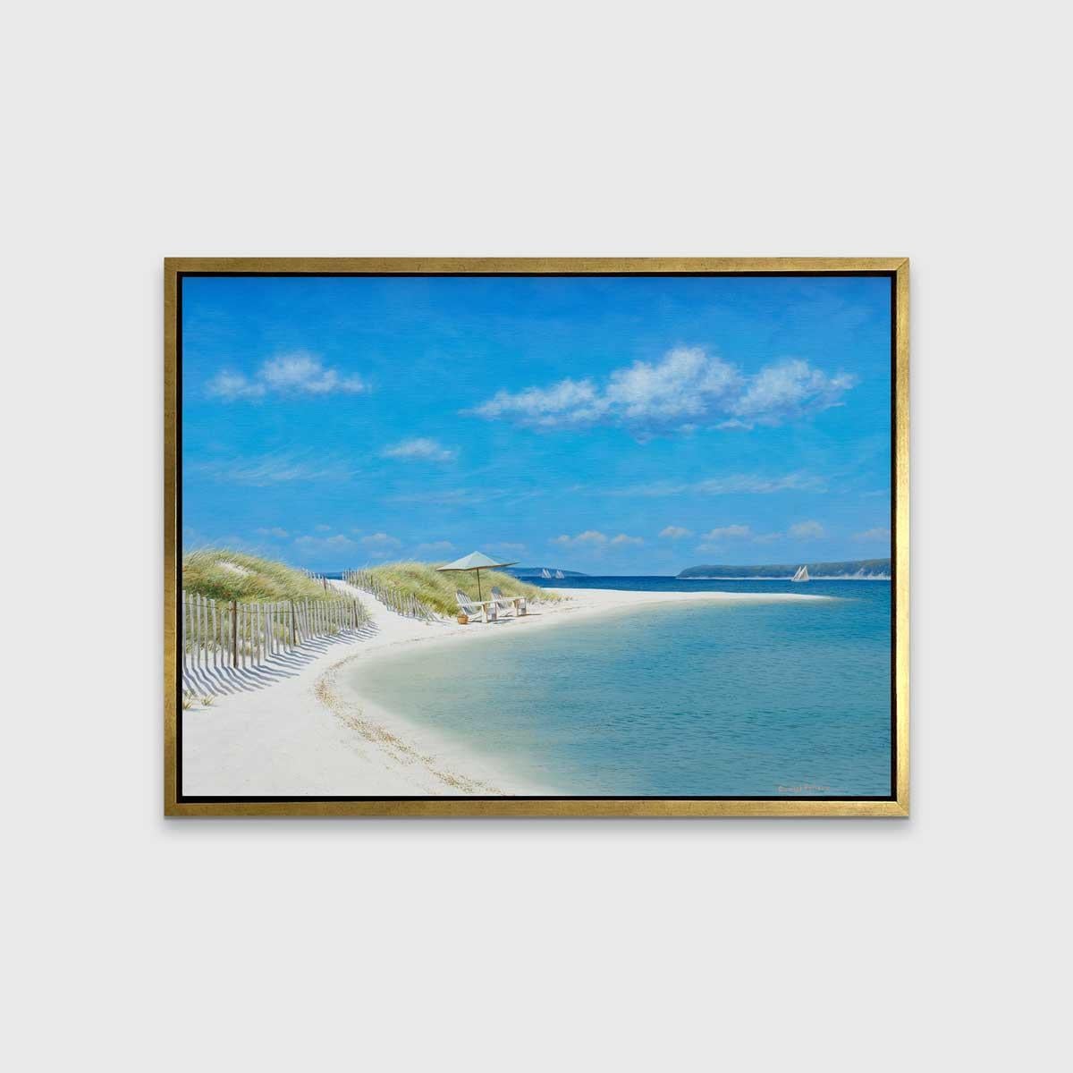 This Limited Edition print by Daniel Pollera is a contemporary realist landscape which depicts a sandy beach lined with wooden fencing. The beach bows inward, with two Adirondack chairs and a beach umbrella facing right, looking out to the water.