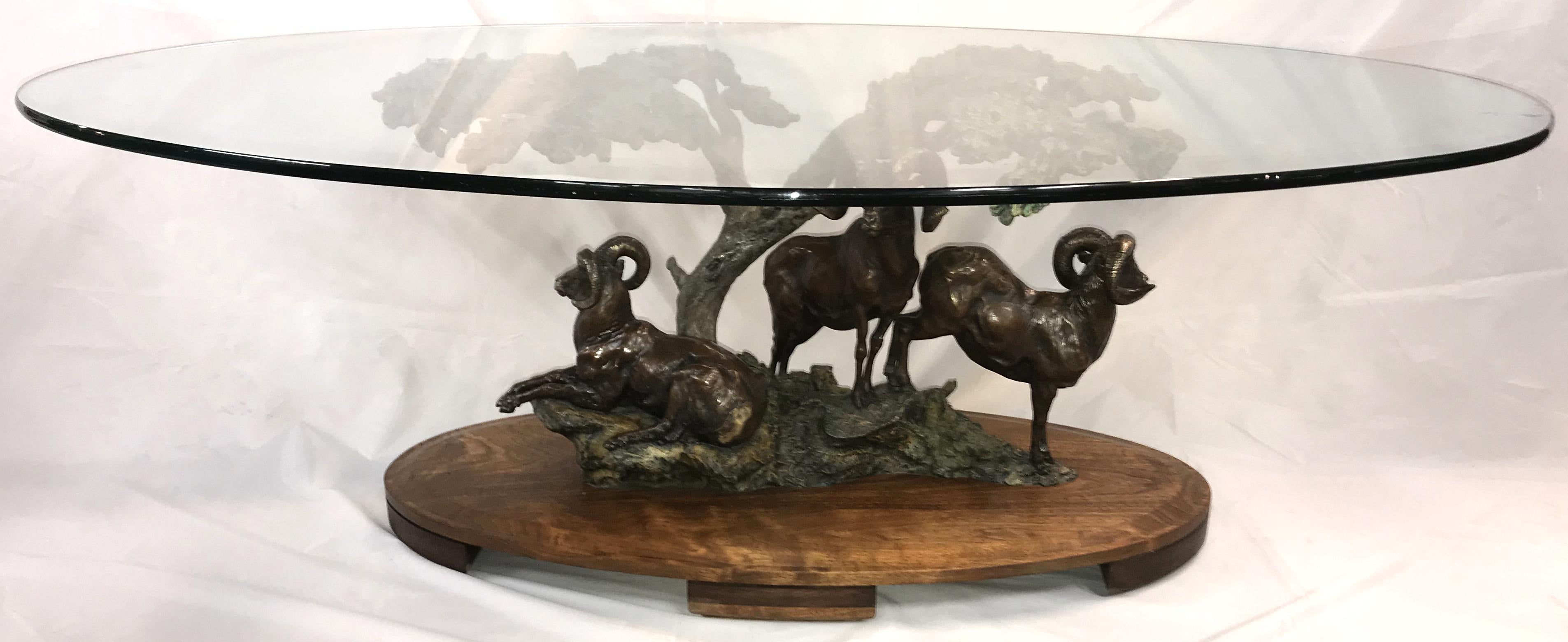 A fine limited edition coffee table, patinated cast bronze table sculpture of three rams under trees by American artist Daniel Ray Parker (b. 1959). Parker was born in Portland, Oregon and was raised in Kalispell, Montana, and was a mostly
