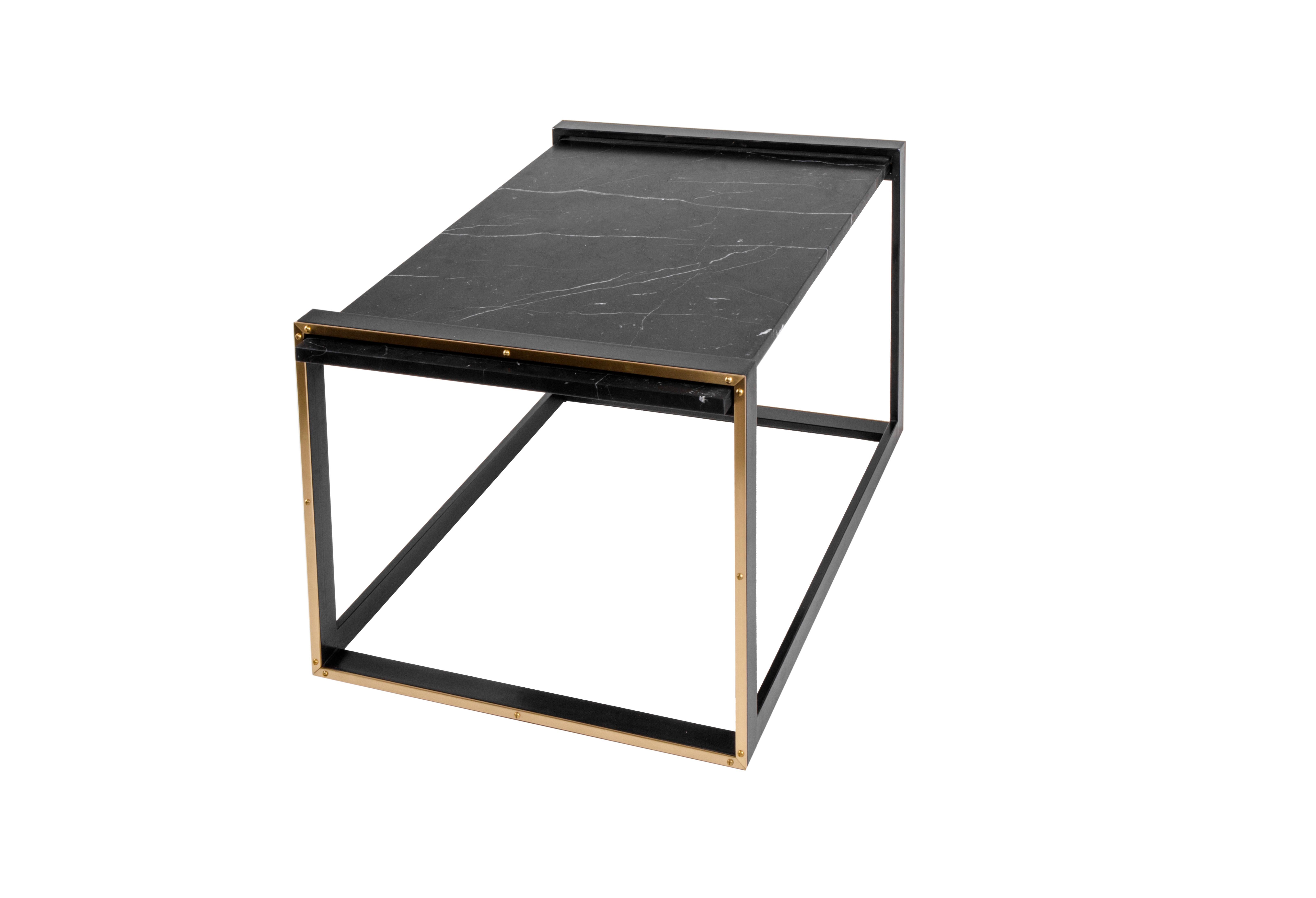 The (wh)ORE HAüS STUDIOS Daniel table is made of blackened steel, marble and brass accents. This table is made to order and can, therefore, be customized. As pictured, blackened Steel, Un-lacquered brushed brass lashings, and Nero Marquina