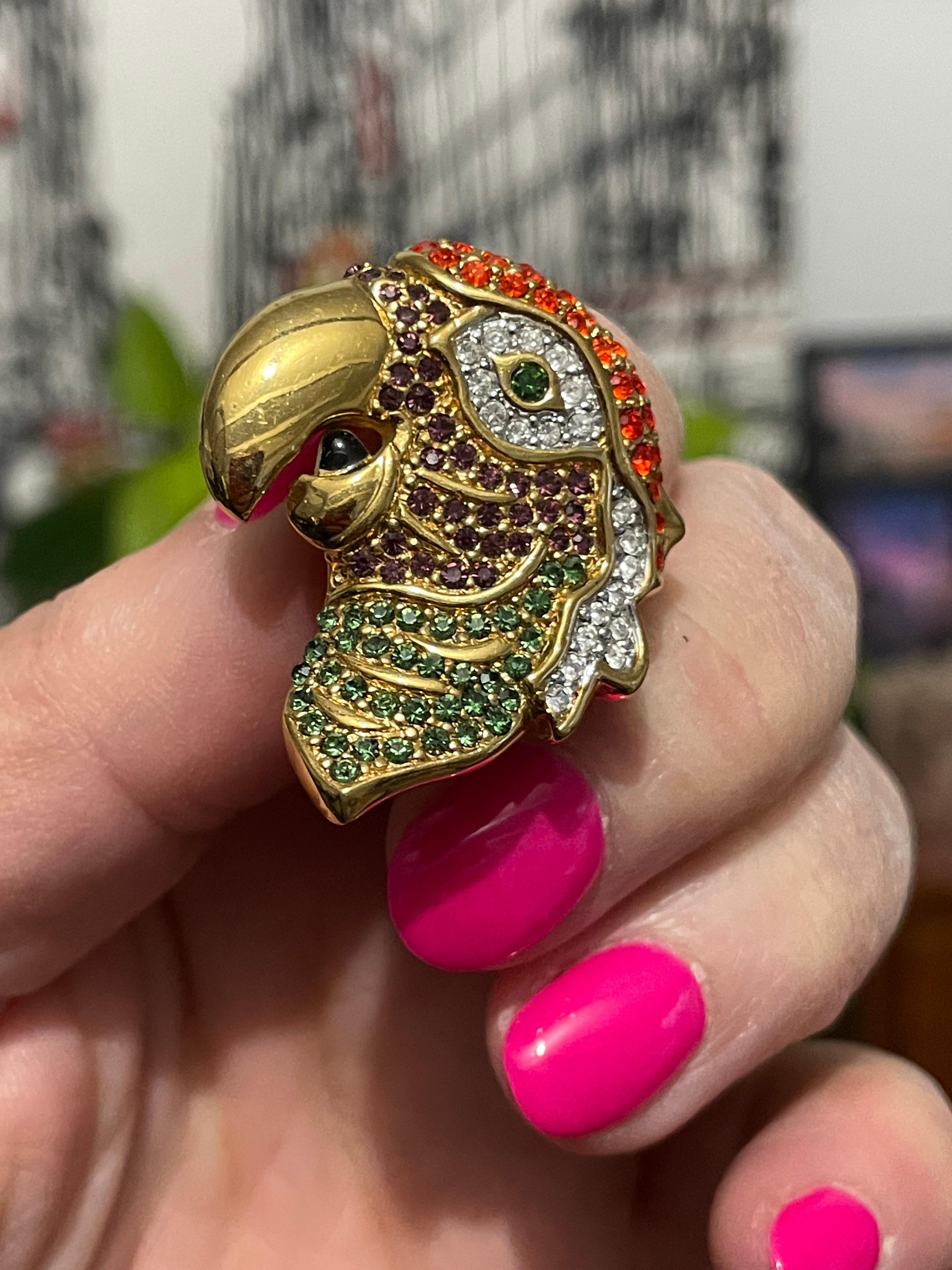 Stunning Parrot Brooch by Swarovski Brooch with Purple, Red, Green and clear Crystals. Measures 1.45 inches x 1.21 inches. More Swarovski listed on our storefront. This is out of a massive collection of Jewelry from one collector. This collection
