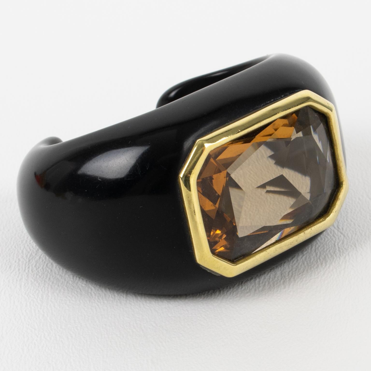 This stunning Daniel Swarovski Paris jeweled lucite cuff bracelet is an incredible piece. French artist Aline Gui designed this bracelet for Daniel Swarovski. The piece features a black lucite cuff shape topped with a massive crystal-cut rhinestone