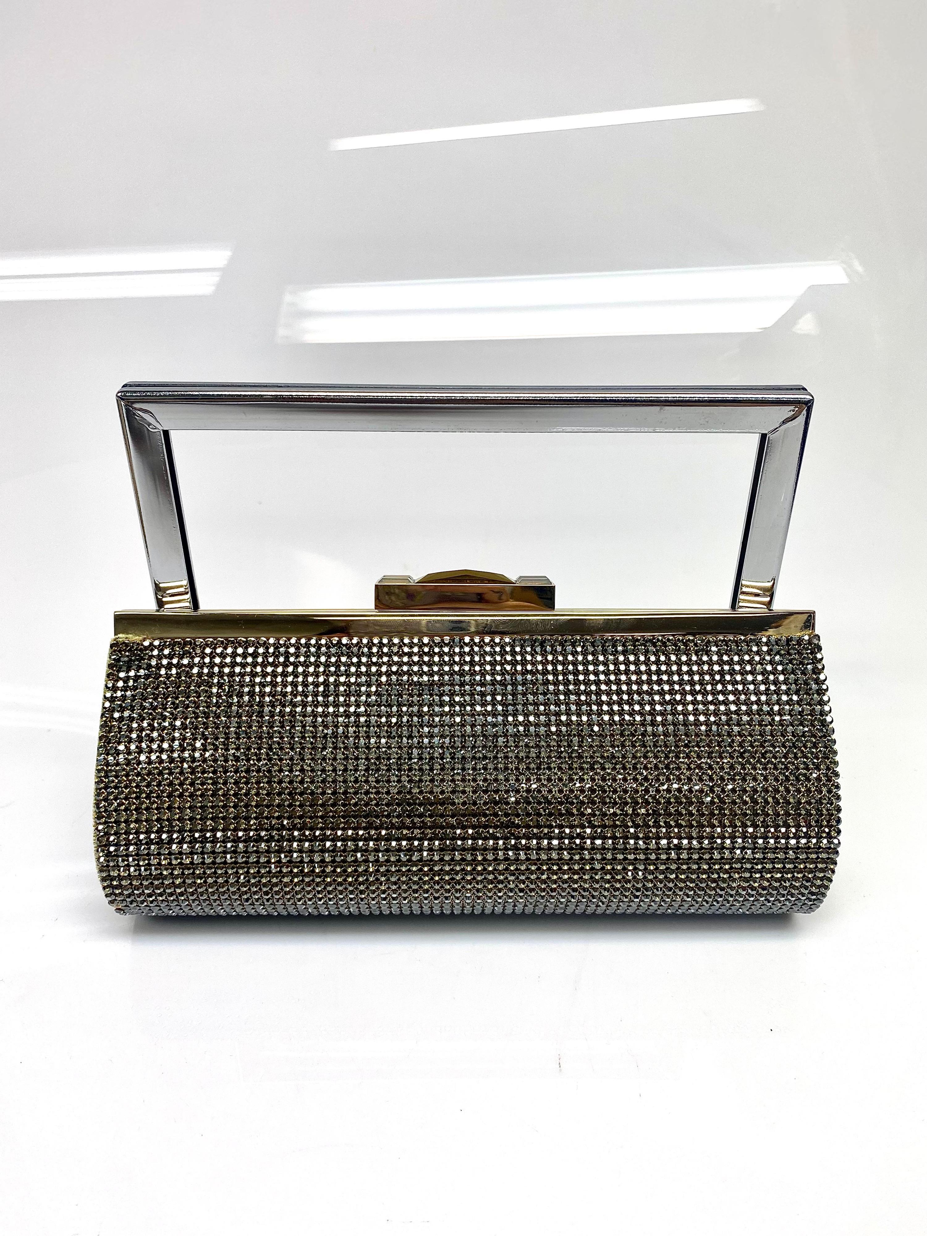 Daniel Swarovski Gold Clutch with Chain Strap. This clutch adorned in Swarovski crystals is the perfect glamorous piece to match with any nighttime outfit. The chain is removable, and the item is in excellent condition. 

Chain length: 9