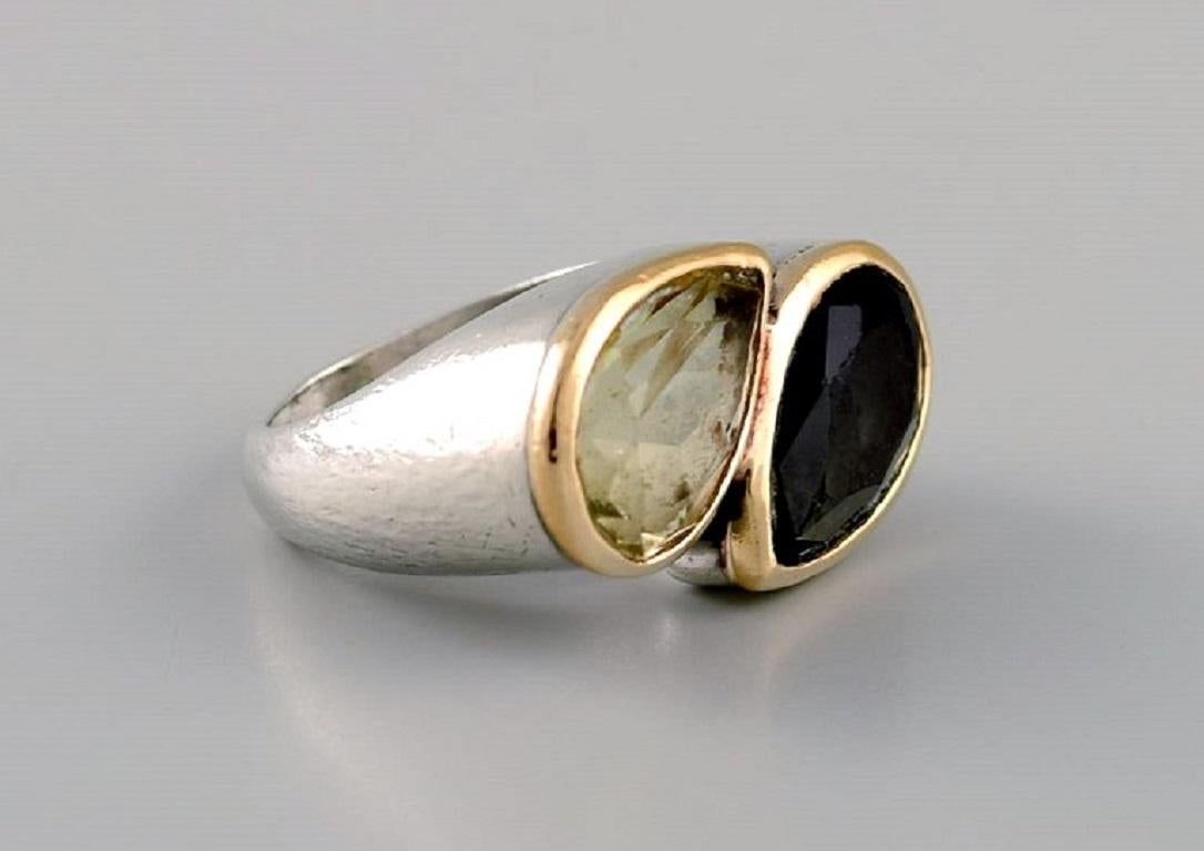 Daniel Swarovski, Paris. Large ring in silver and 18 carat gold adorned with two semi-precious stones. 
Late 20th century.
Diameter: 18 mm.
US size: 7.75.
In excellent condition.
Stamped.
In most cases, we can change the size for a fee (USD 50) per