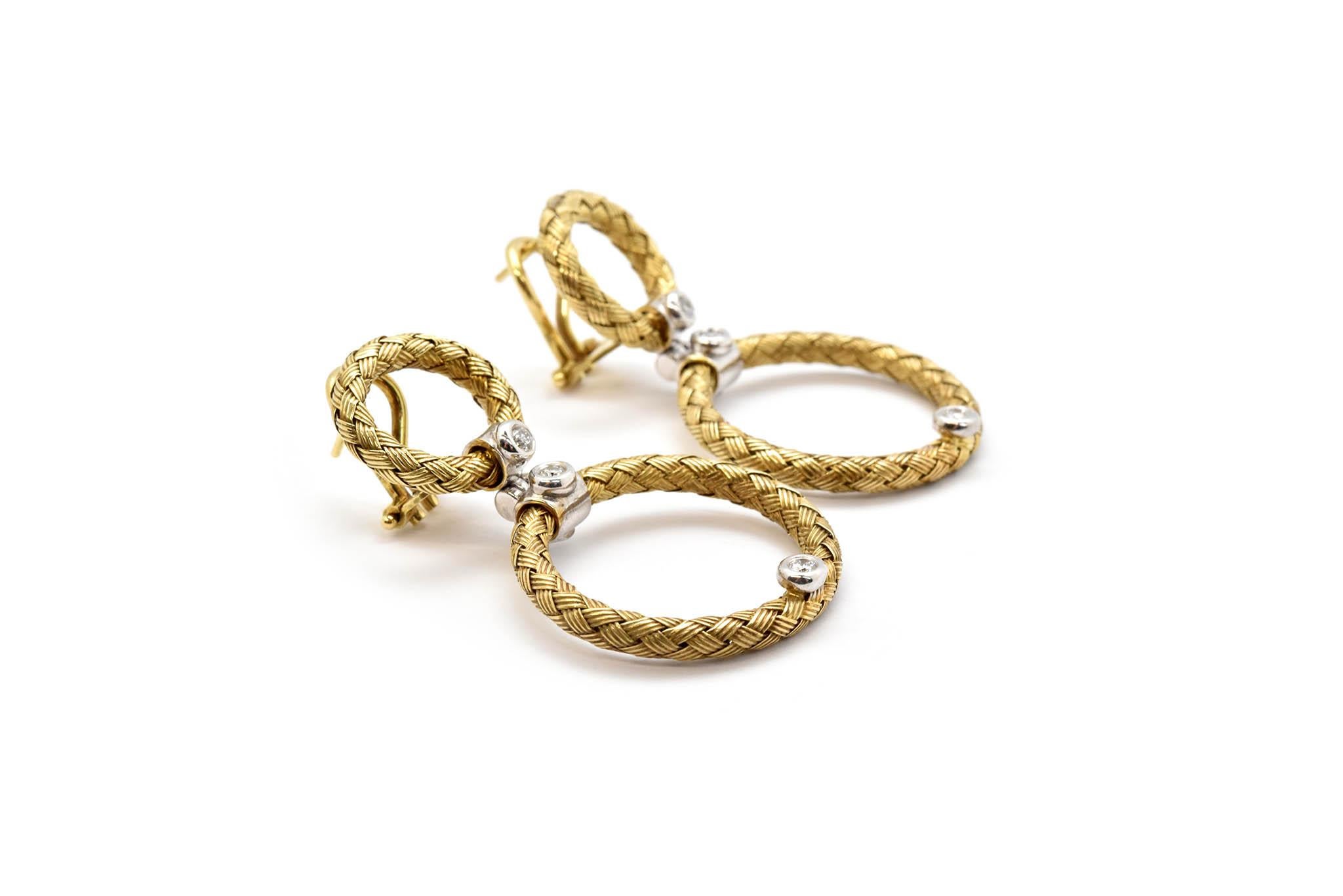 These earrings are made in 14k yellow gold by designer Daniel W. The earrings have a woven texture to them, and they are set with round diamonds. The diamonds have a total weight of 0.30ct, and they are graded H in color and SI in clarity. The