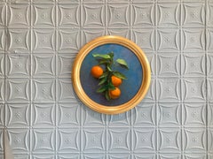 "Oranges" classical still life, fresh-cut branch of oranges hanging on blue wall