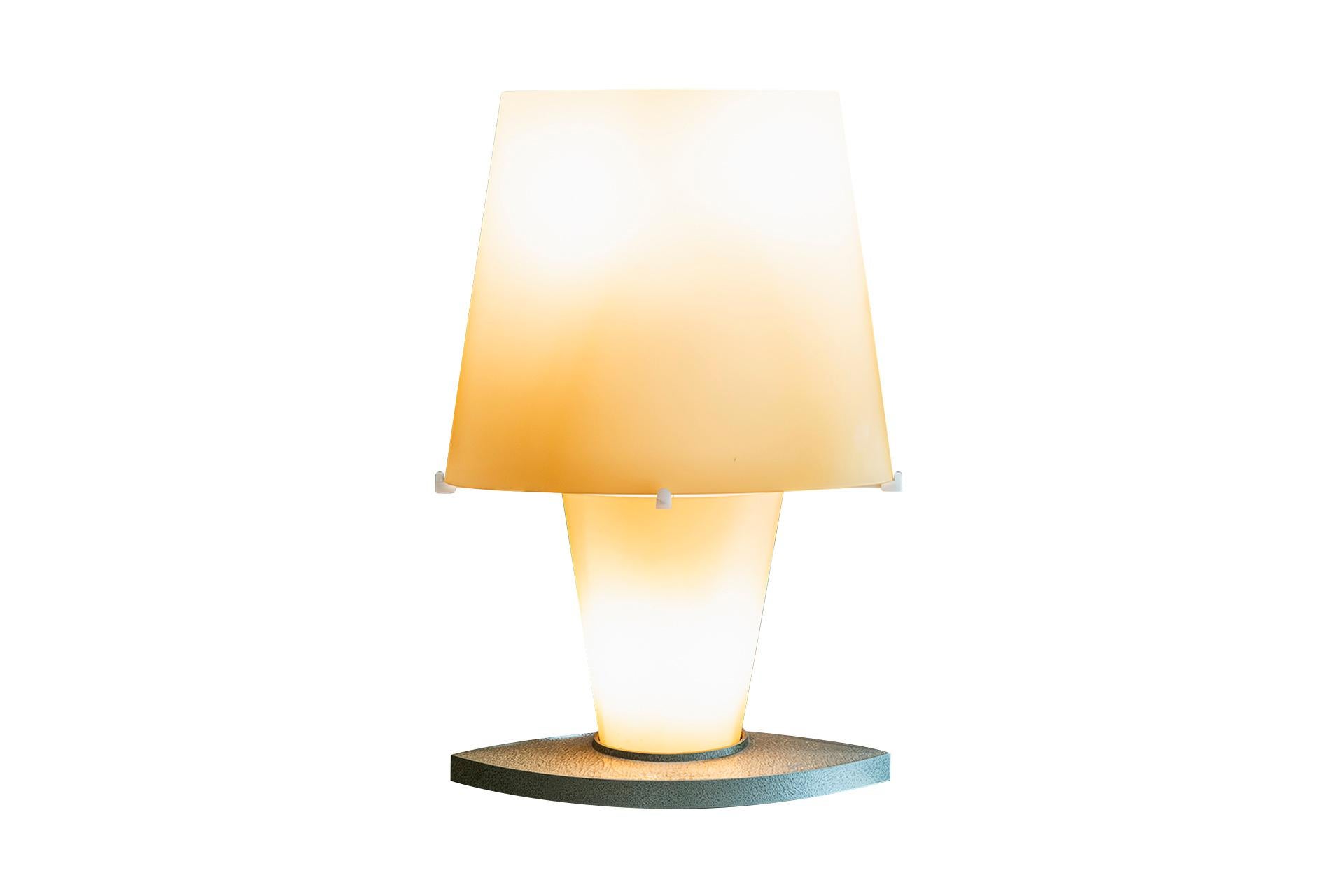 Daniela Puppa (1947) for Fontana Arte, table lamp model 2850, 
Aluminum and yellow sandblasted glass,
circa 1990, Italy. 

Measures: Width 42 cm, height 61 cm, depth 15 cm.

An eclectic architect and designer, she has made style and elegance
