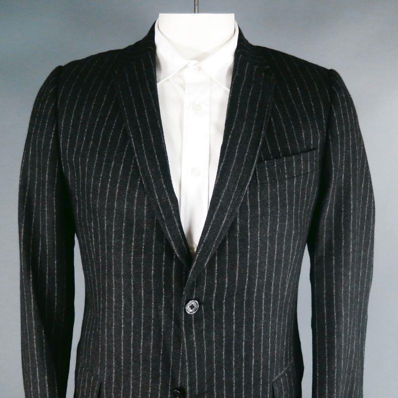 DANIELE ALESSANDRINI suit comes in charcoal chalk stripe wool and includes a single breasted, two button sport coat with a notch lapel and matching flat front trousers.
Good Pre-Owned Condition. 

Marked:   IT 54 

Measurements: 
  -JacketChest: 44