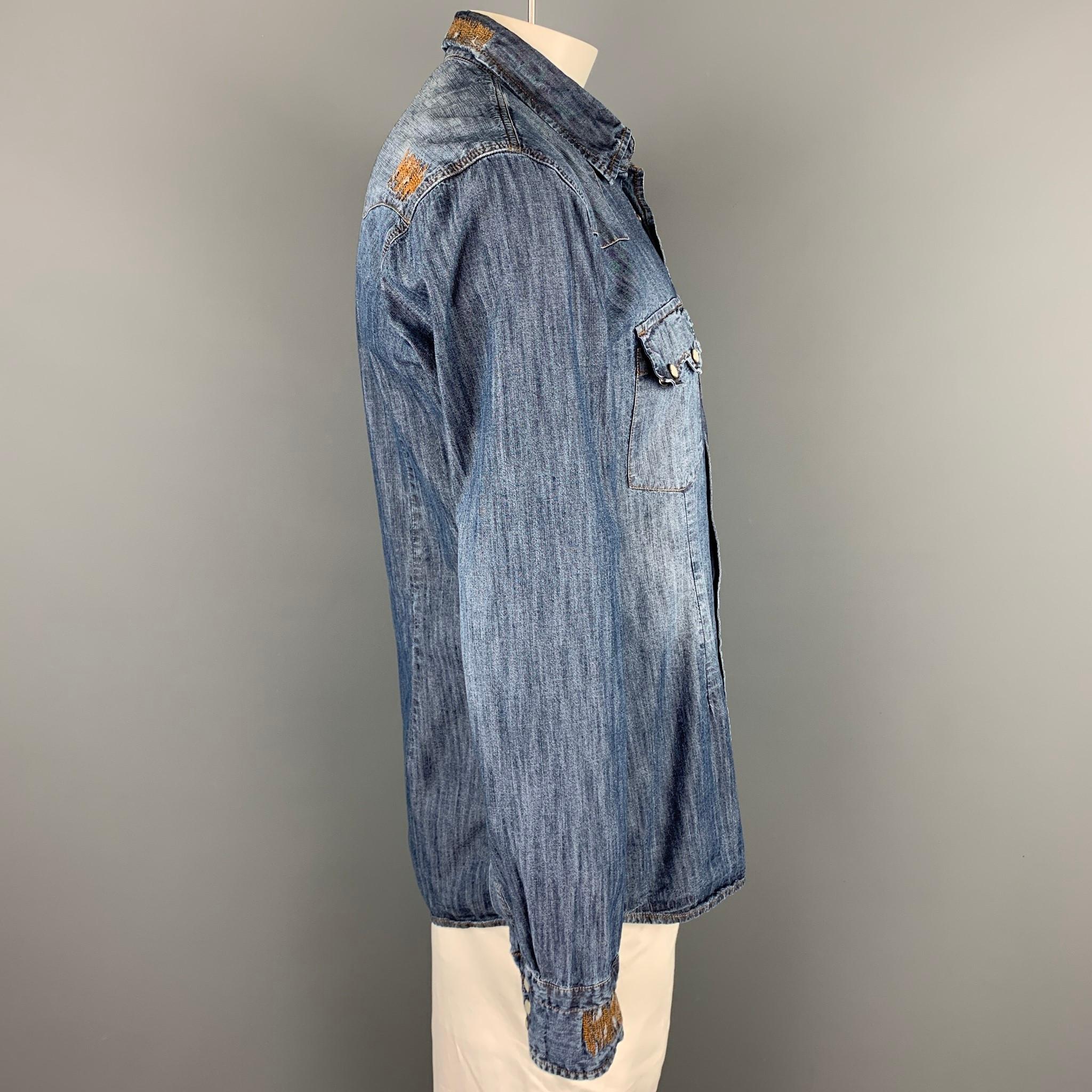 DANIELE ALESSANDRINI long sleeve shirt comes in a indigo material with contrast stitching featuring a button up style, mother of pearl buttons, back patch detail, and a spread collar. 

Very Good Pre-Owned Condition.
Marked: