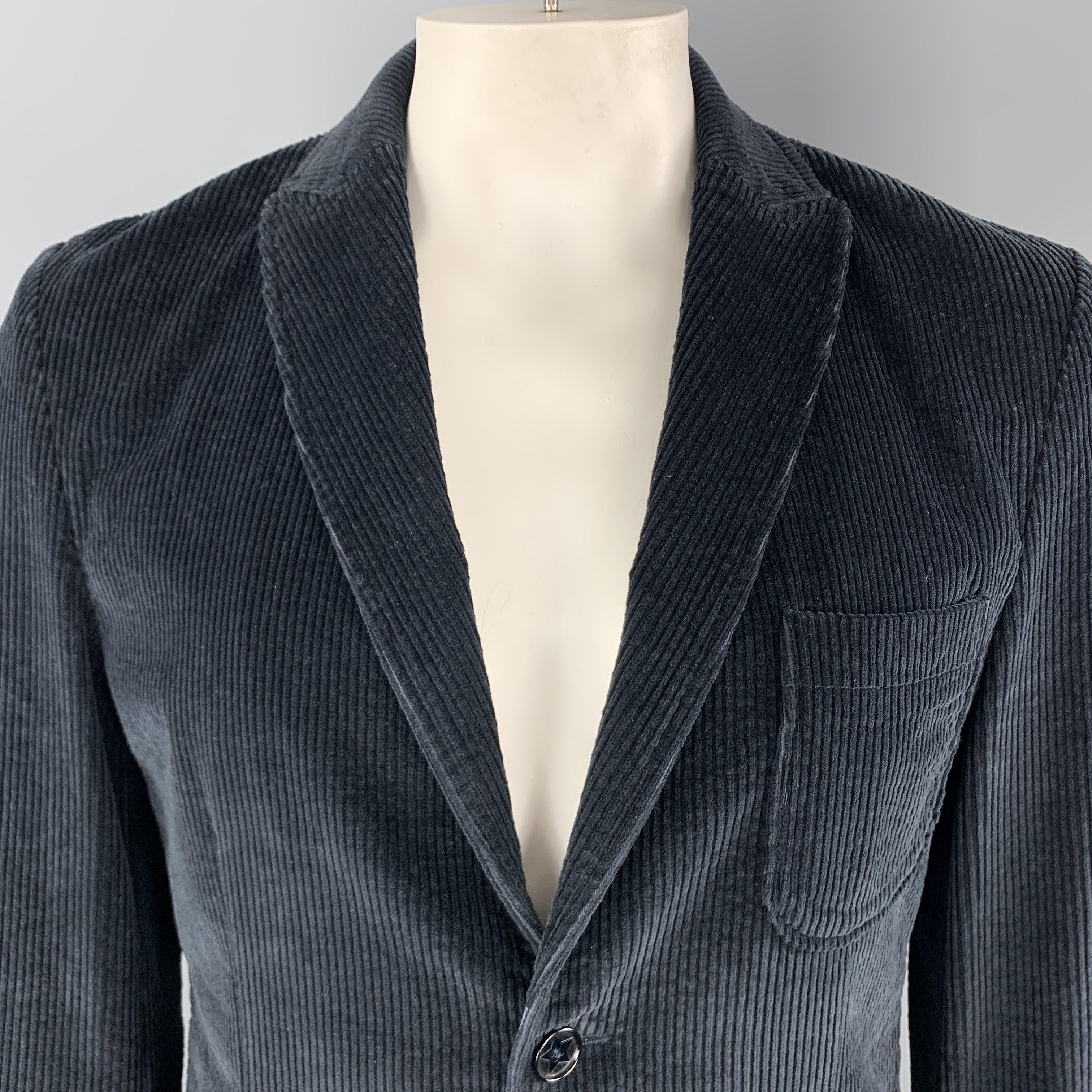 DANIELE ALESSANDRINI Sport Coat
comes in a navy corduroy material, with a peak lapel, patch and slit pockets, two buttons at closure, single breasted, unbuttoned cuffs and a single vent at back. Made in Italy.
Excellent Pre-Owned Condition.