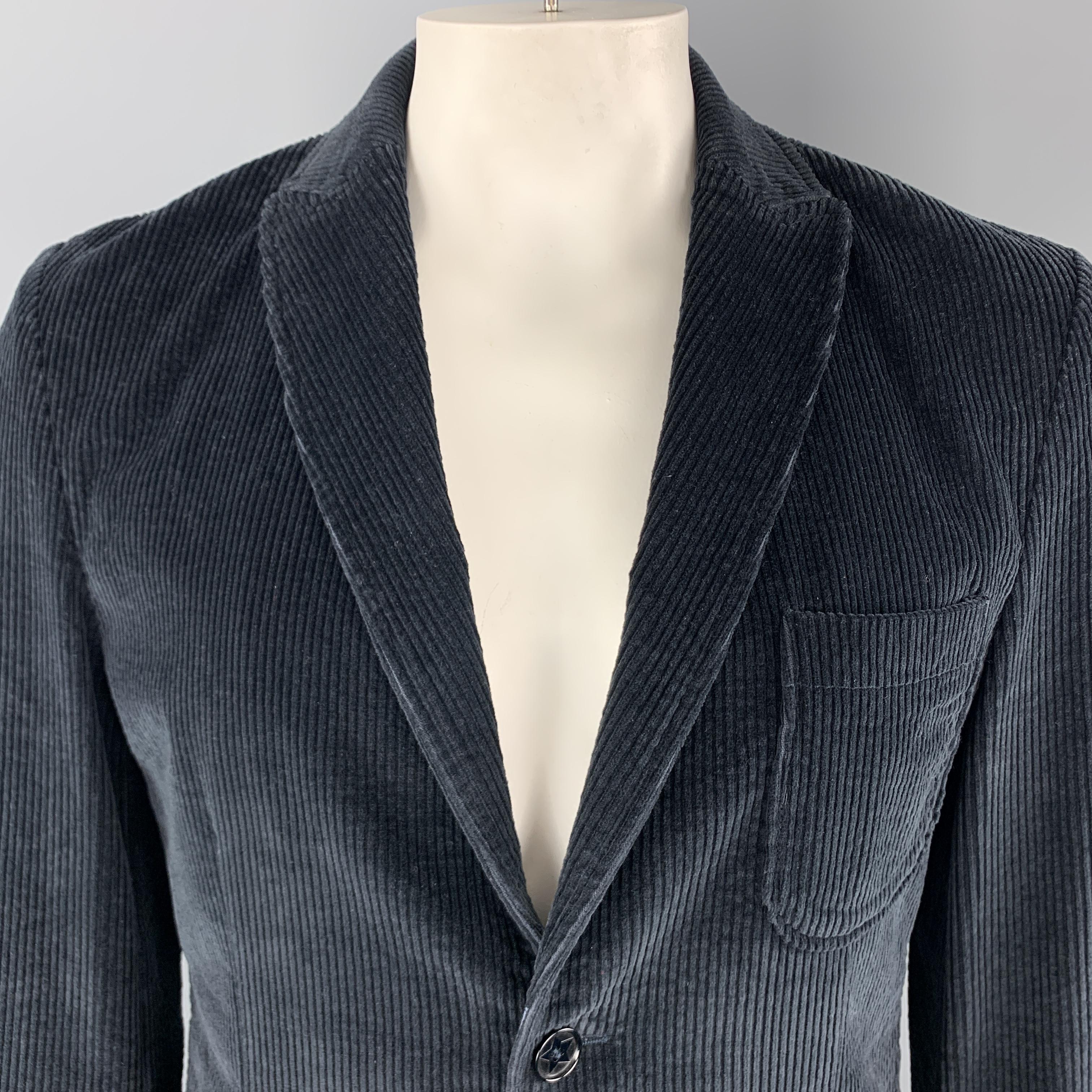 DANIELE ALESSANDRINI Sport Coat comes in a navy corduroy material, with a peak lapel, patch and slit pockets, two buttons at closure, single breasted, unbuttoned cuffs and a single vent at back. Made in Italy. 

Excellent Pre-Owned