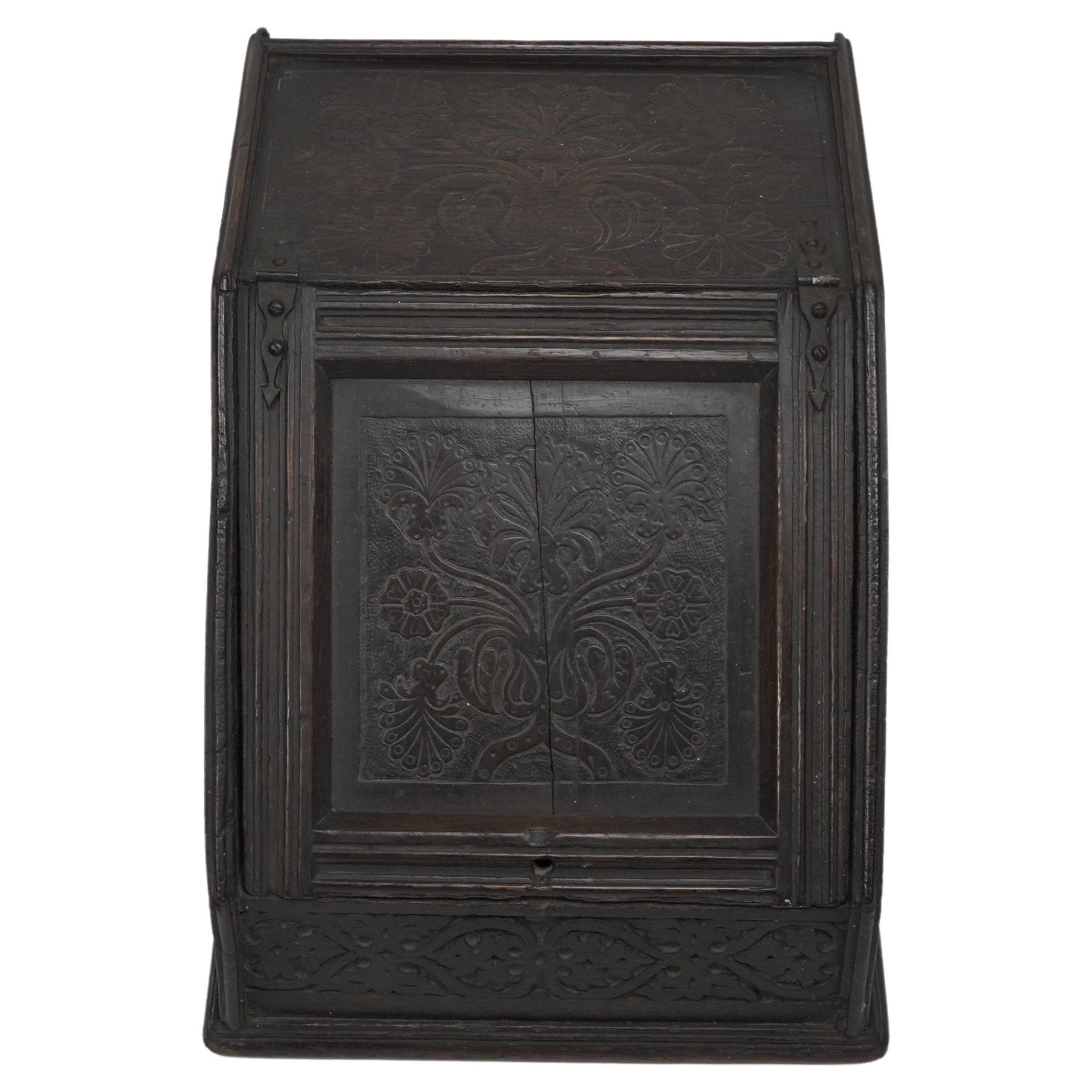 An Aesthetic Movement dark oak coal box in the style of Daniel Cottier. With all over shallow carved floral decoration.
