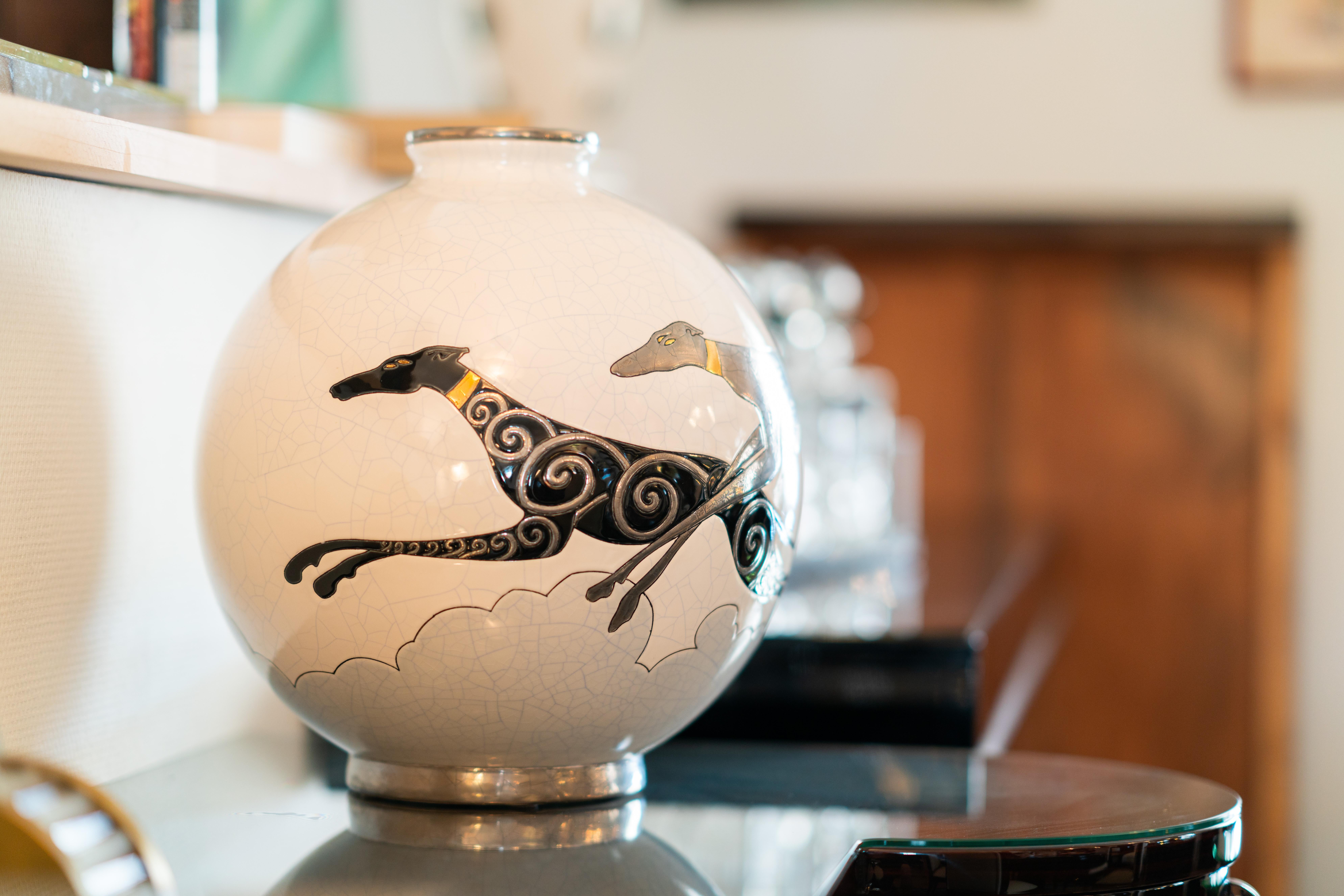 Emaux de Longwy ceramic vase with craqueling glaze
White body with greyhounds 
Limited edition of 50 objects 

Danillo Curetti (1953-1993) was one of the first great names in the contemporary creations of Les Emaux de Longwy. The edition of this