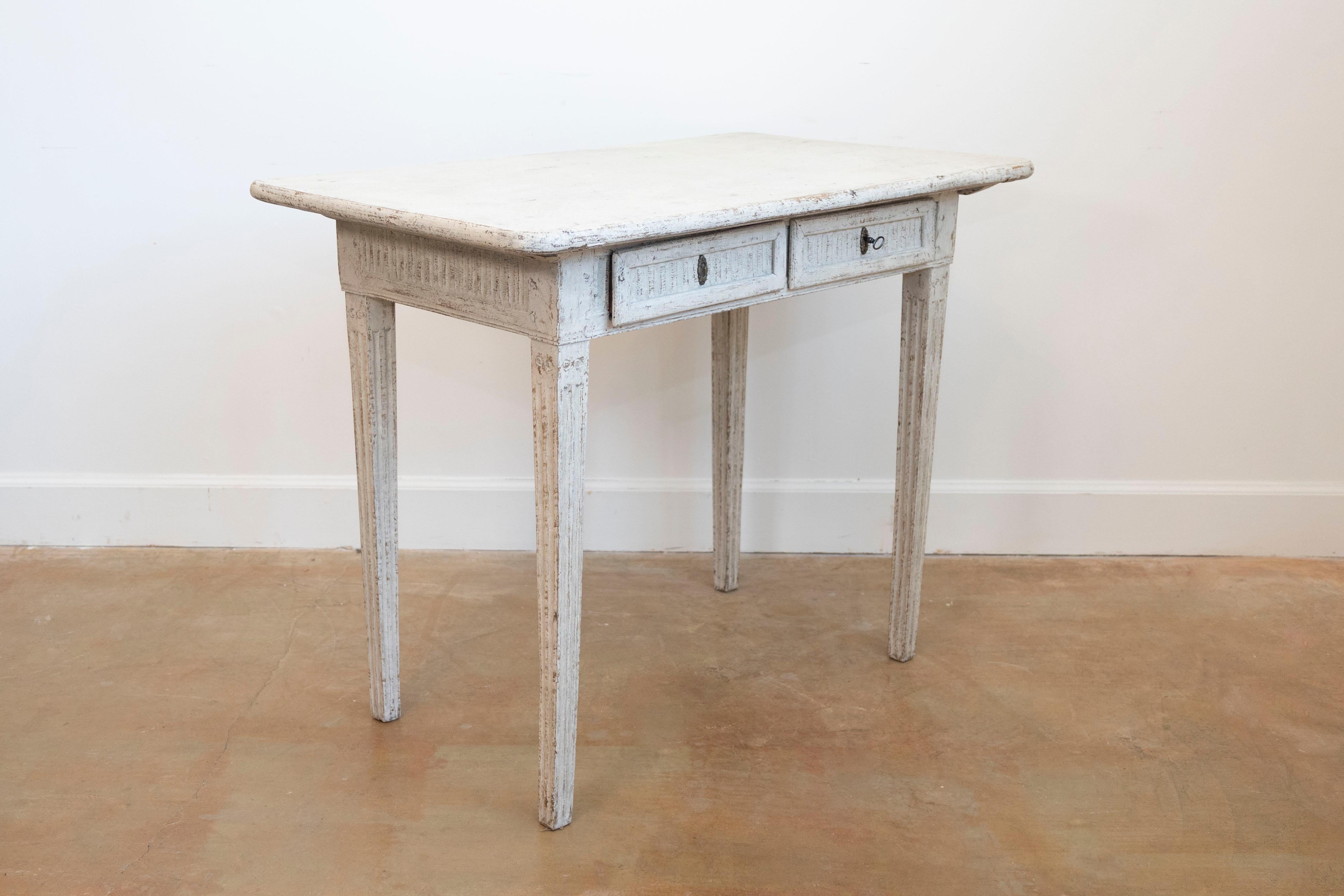 A Danish Louis XVI period painted wood console table from the early 19th century with two drawers, fluted motifs and tapered legs. Created in Denmark during the early years of the 19th century, this painted console table showcases the stylistic