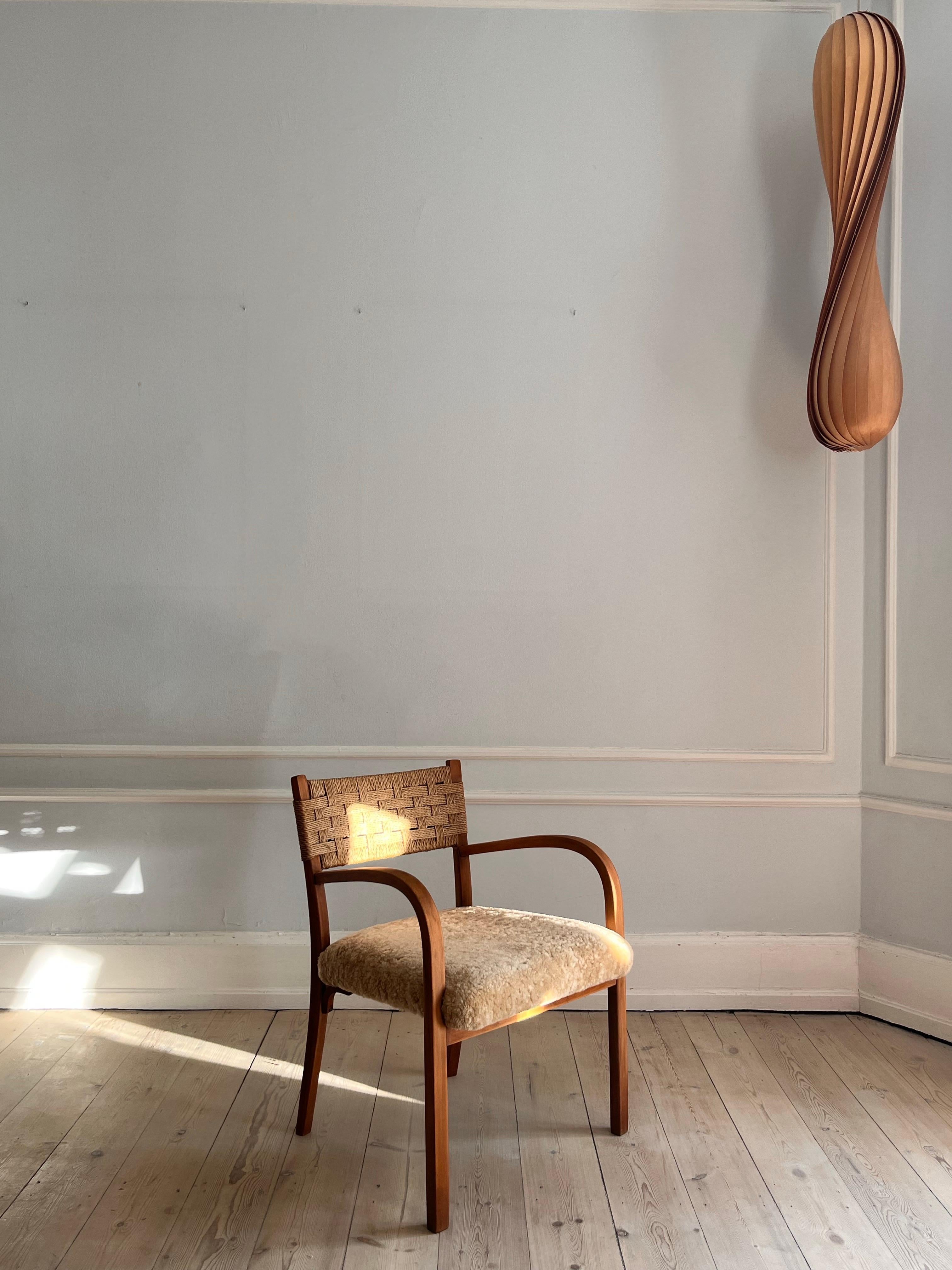Lambskin Danish 1930s armchair with reupholstered seat i soft lambskin For Sale