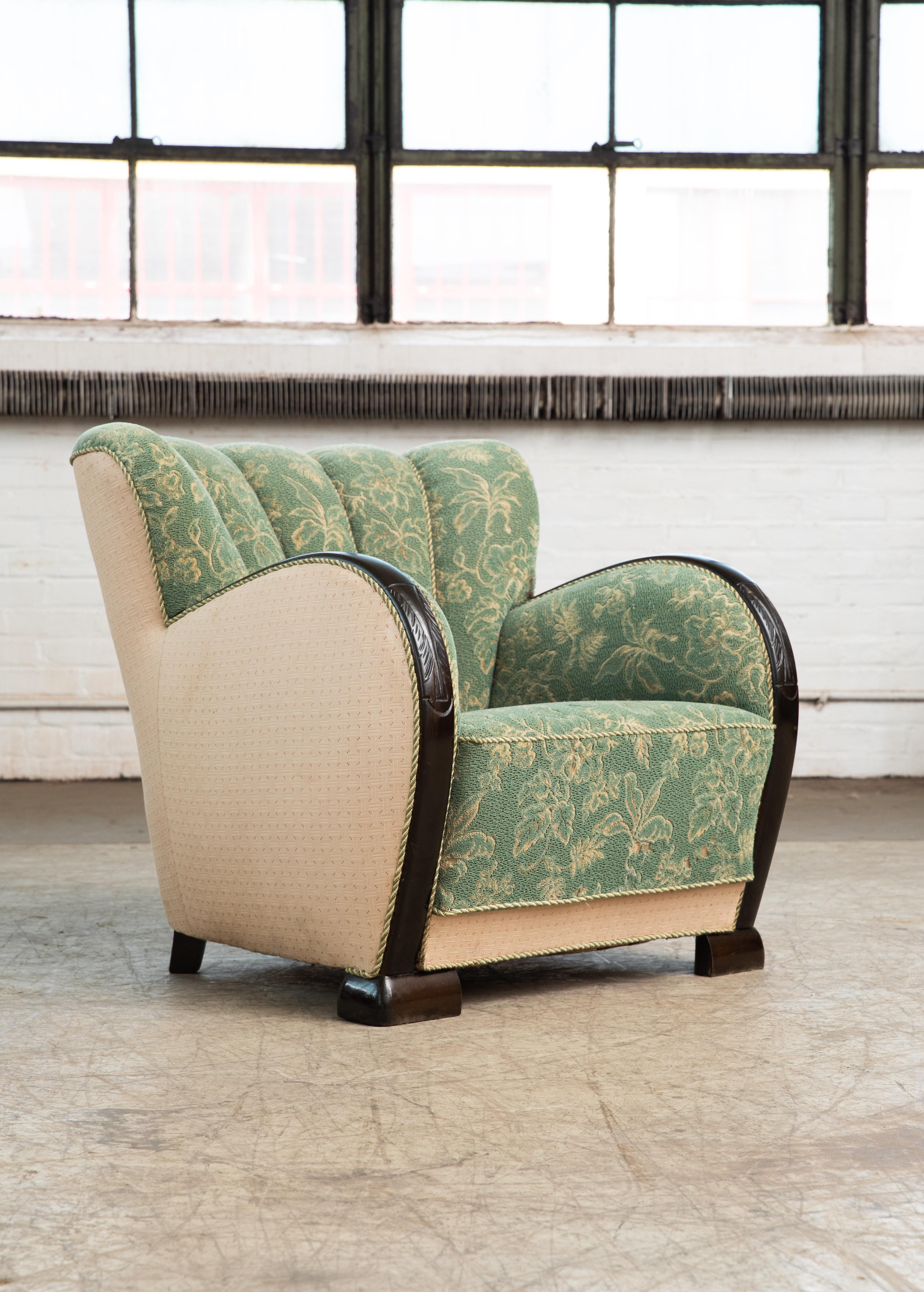 Exuberant, curvy and very eye-catching Danish club chair from the 1930s or 1940s. Set on beech feet typical of the period and with a channeled back reminiscent of sports car seats of the era. Sturdy and sound construction with frame and legs made