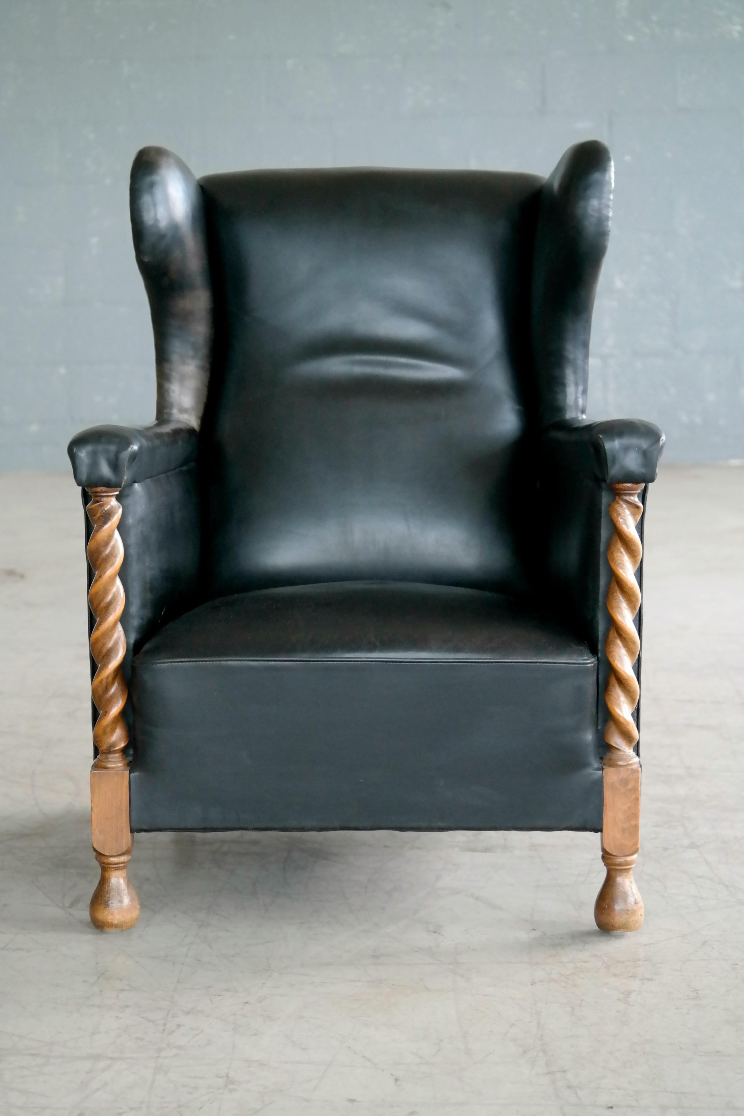 Scandinavian Modern Danish 1930s Large Scale Club or Wingback Chair in Black Leather and Carved Oak