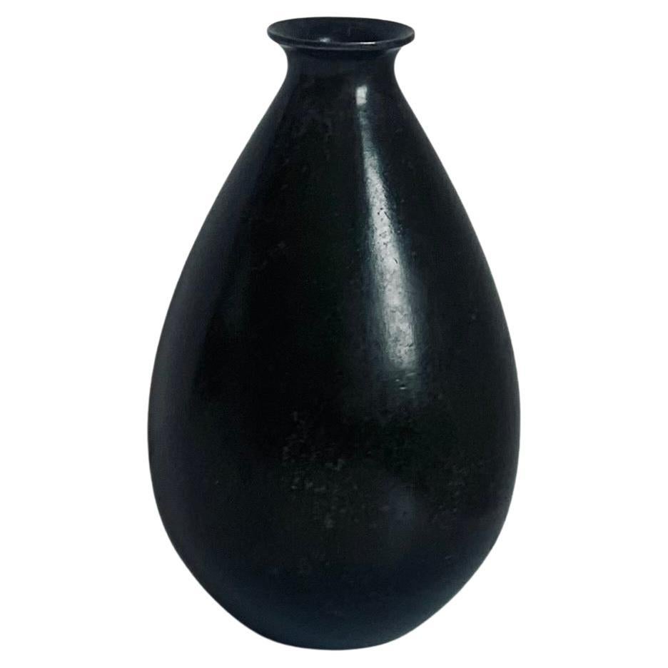 Danish modern drop shaped vase in patinated discometal, model 1521, by Just Andersen, 1930s. Very decorative piece with nice weight and sleek design. 
Stamped JUST, DENMARK, D, 1521.

Ib Just Andersen (1884-1943) was a Danish silversmith and