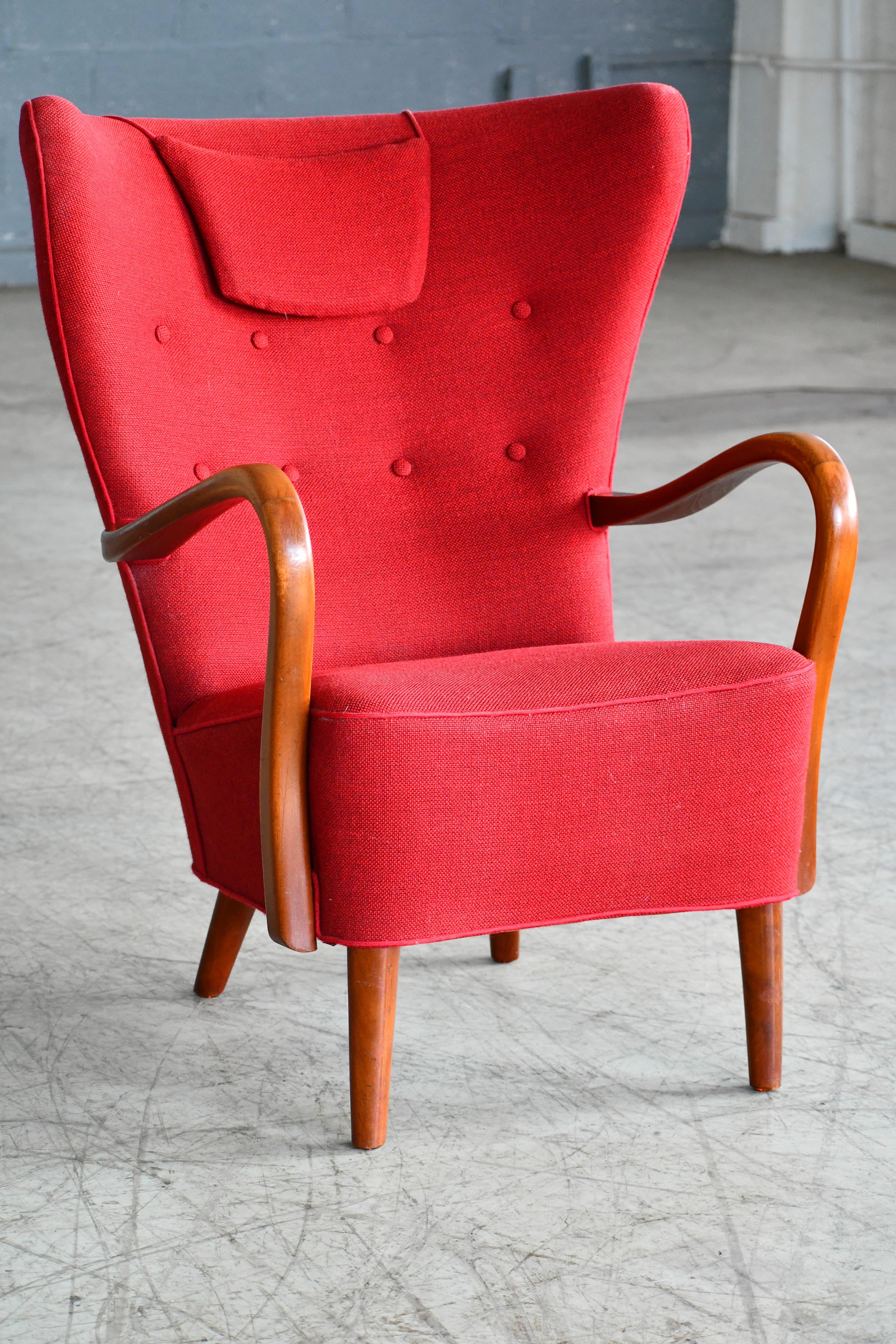 Classic elegant Danish high back armchair from the 1940s by Alfred Christensen for Slagelse Mobelvaerk with open armrests in beautifully curved stained beech. Nice slim elegant silhouette. Solid and sturdy construction with the fabric in clean