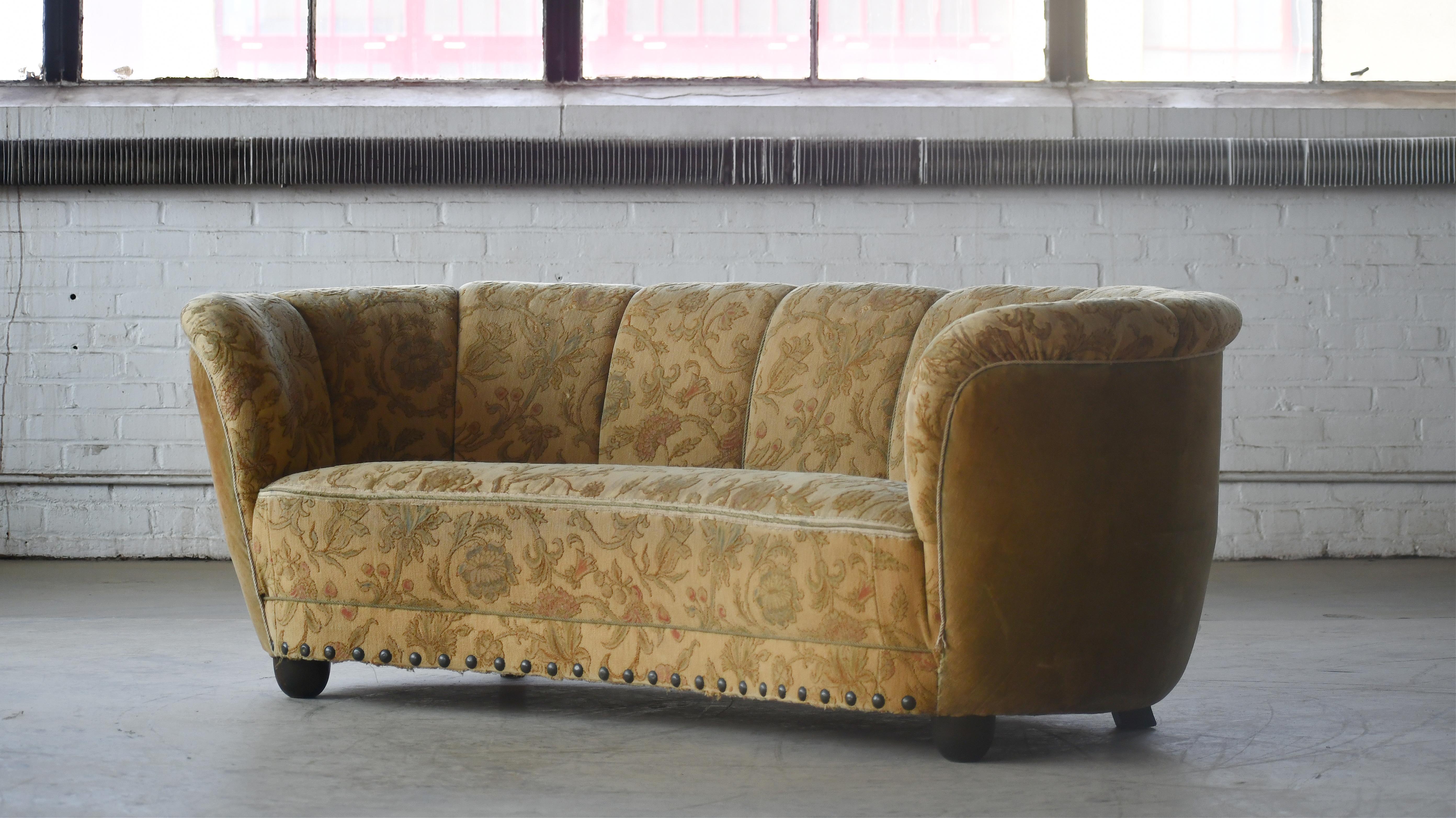 Banana shaped Viggo Boesen style curved sofa made in Denmark in the 1940s. This sofa will make a strong statement in any room. Beautiful round lines and iconic block feet feet normally associated with Viggo Boesen. Solid and sturdy. The original
