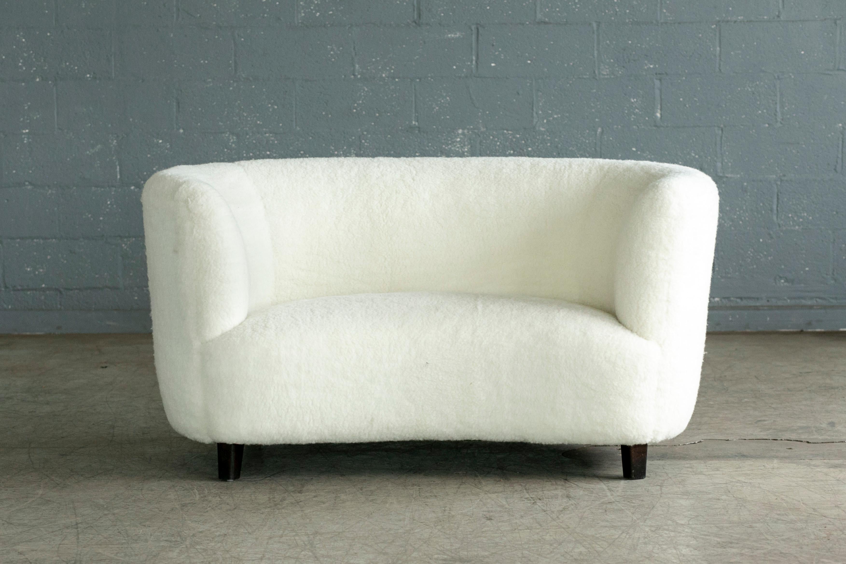 Banana shaped Viggo Boesen style curved two-seat sofa or loveseat made in Denmark in the 1940s. This sofa will make a strong statement in any room. Beautiful round organic voluptious lines. Fully refurbished and newly upholstered with ivory